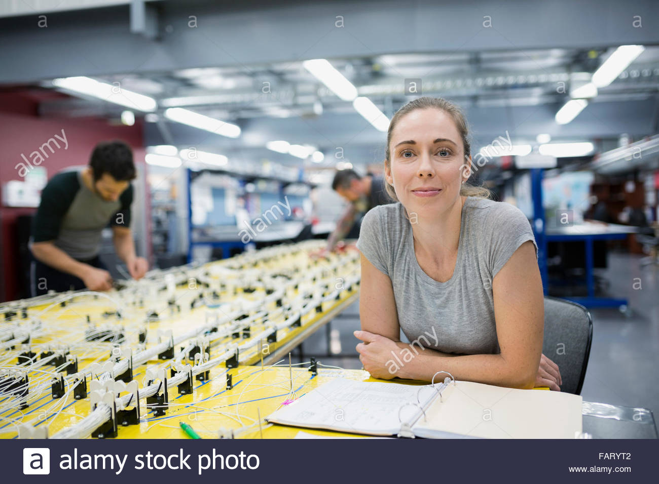 Portrait confident female helicopter technician at wiring harness Stock