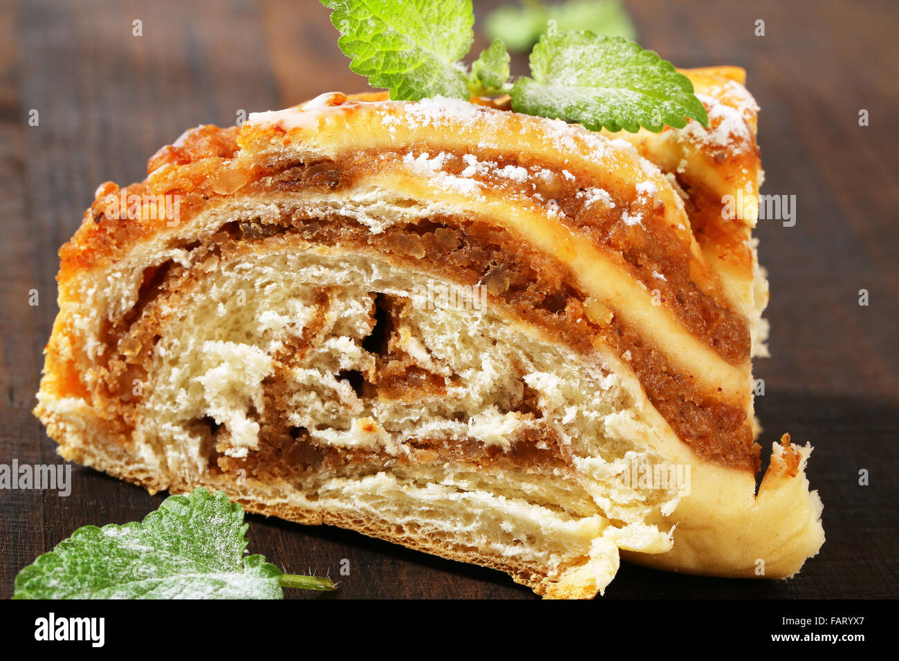 slice of yeast cake with nut filling Stock Photo