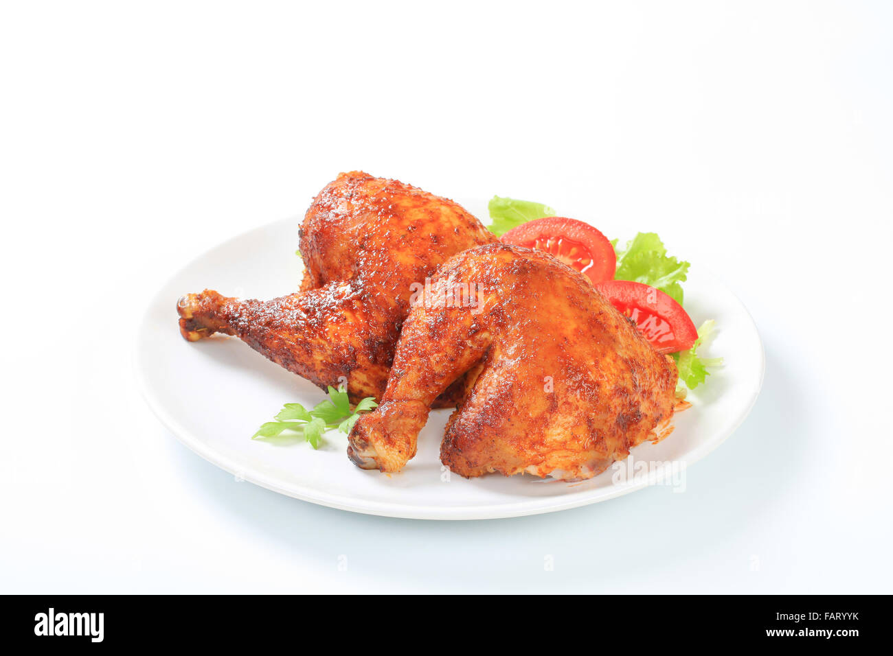 Two garlic roasted chicken leg quarters on plate Stock Photo Alamy
