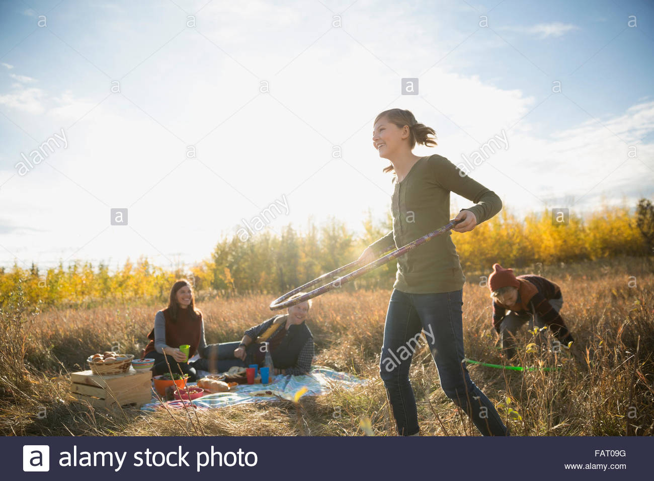 Family enjoying picnic spinning in plastic hoops Stock Photo