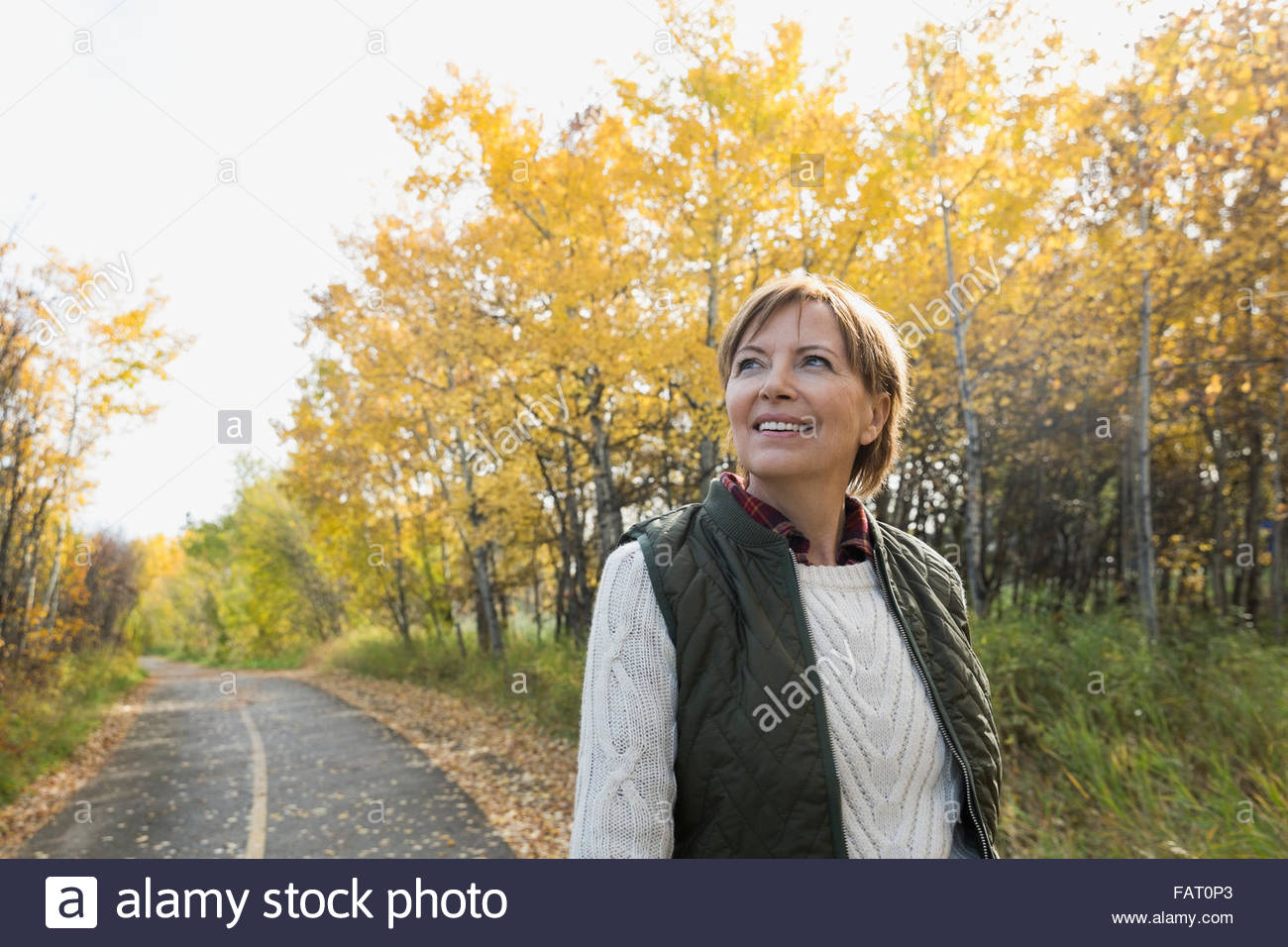 Woman walking through trees hi-res stock photography and images - Alamy