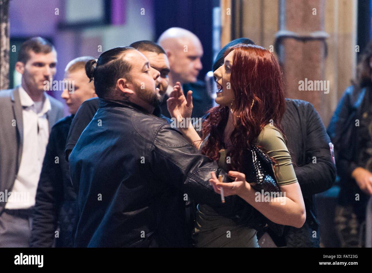 Pictured: A woman has an altercation with a nightclub bouncer. Re: New Year's Eve in Cardiff, South Wales, UK. Early hours of Fr Stock Photo
