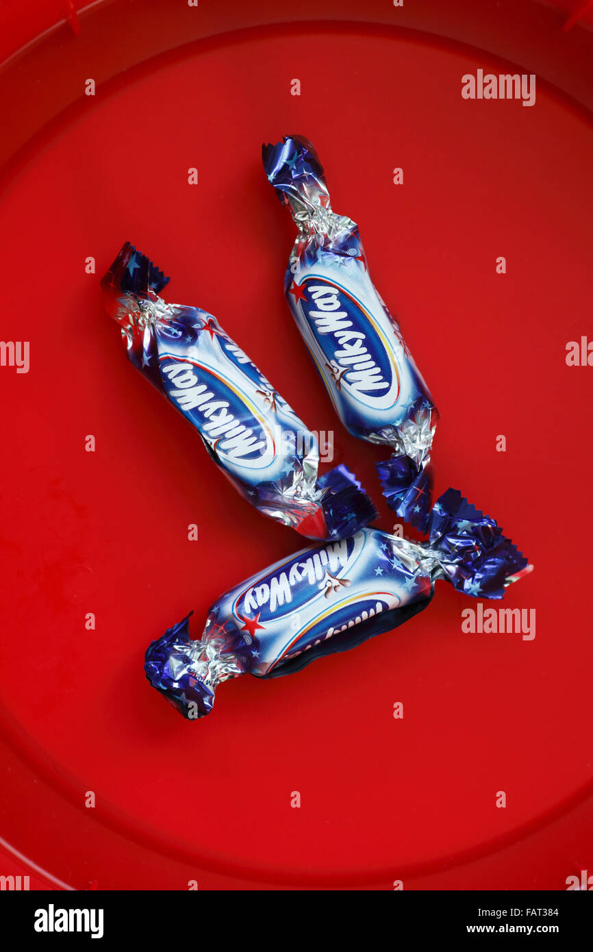 Milky Way fun size bar left in the bottom of a tub of chocolates. Stock Photo