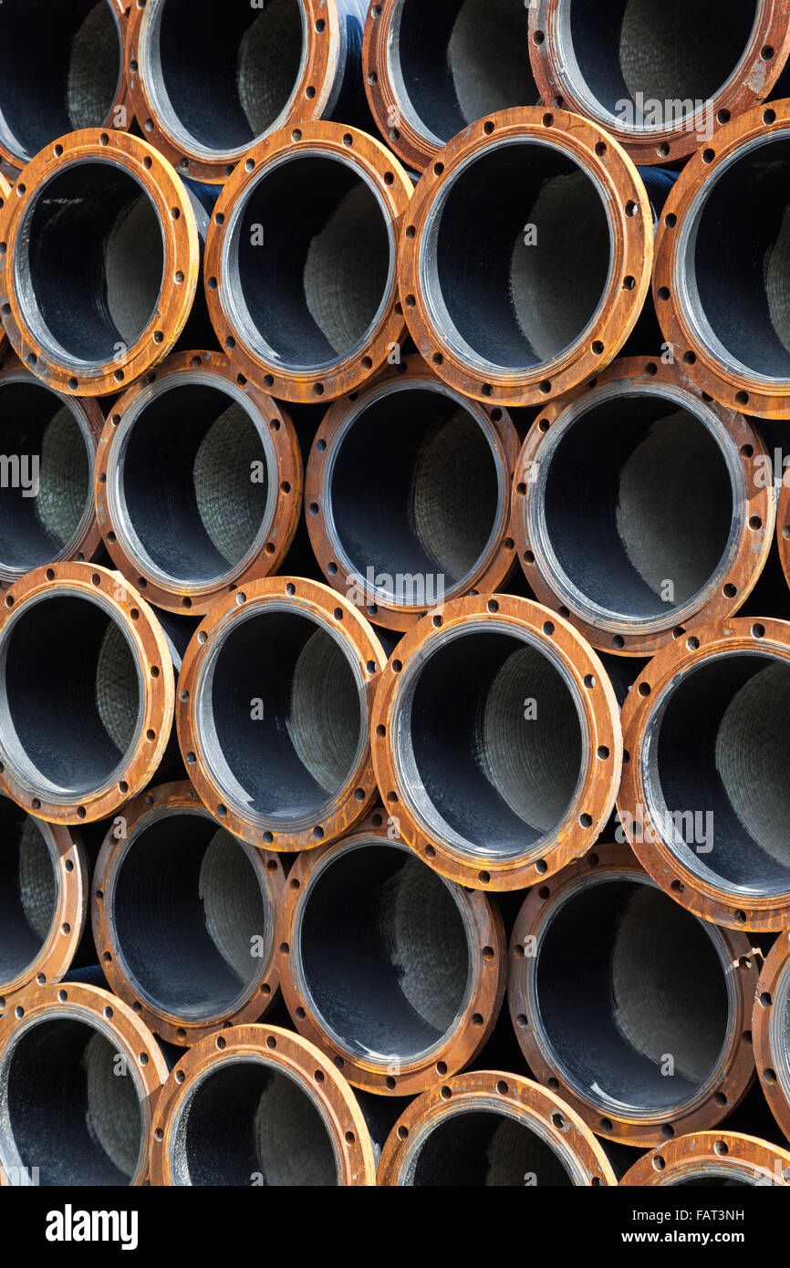 Stacked steel pipe industrial texture background vertical Stock Photo