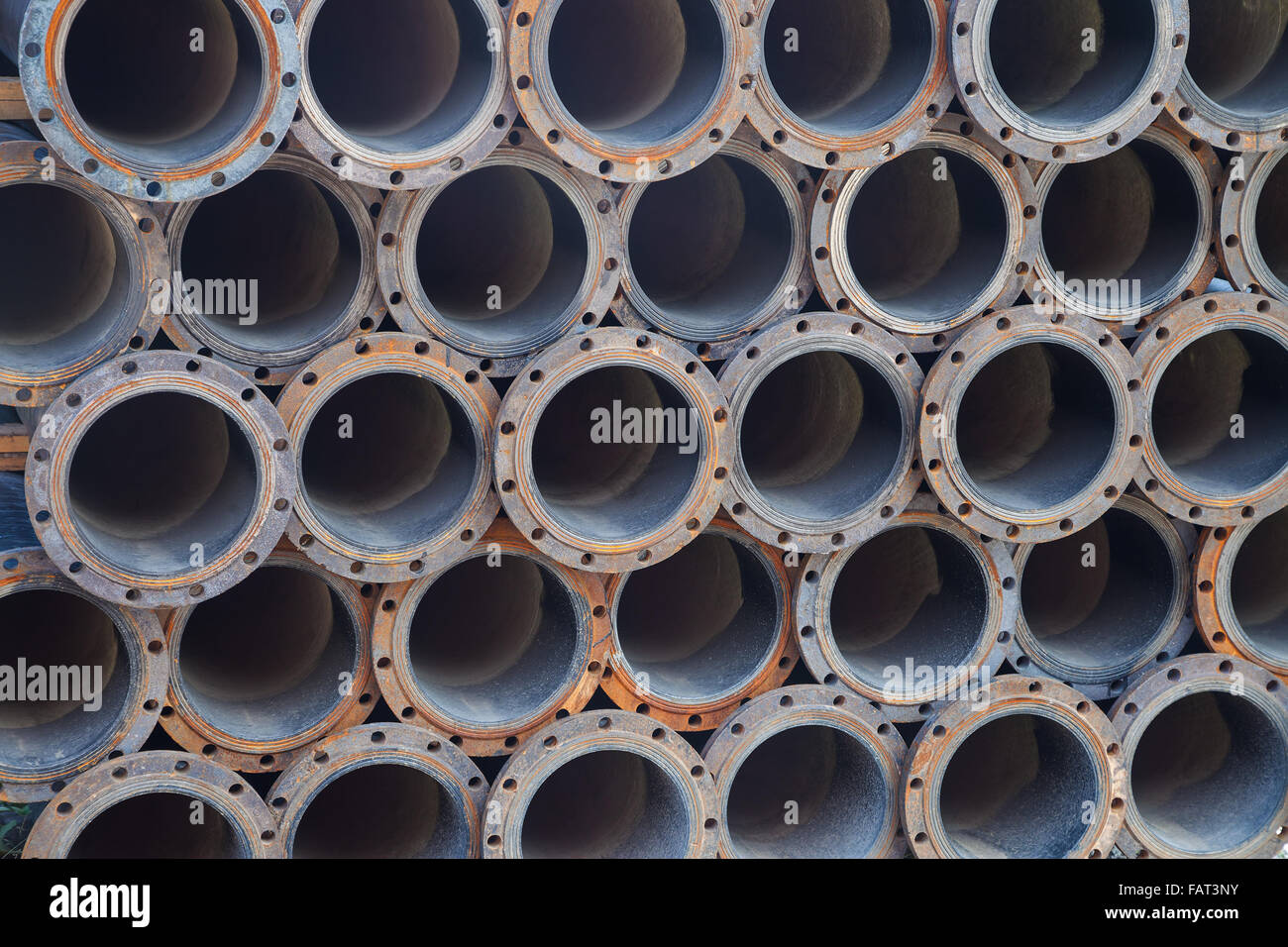 Stacked steel pipe bundle in industrial stockyard texture background Stock Photo