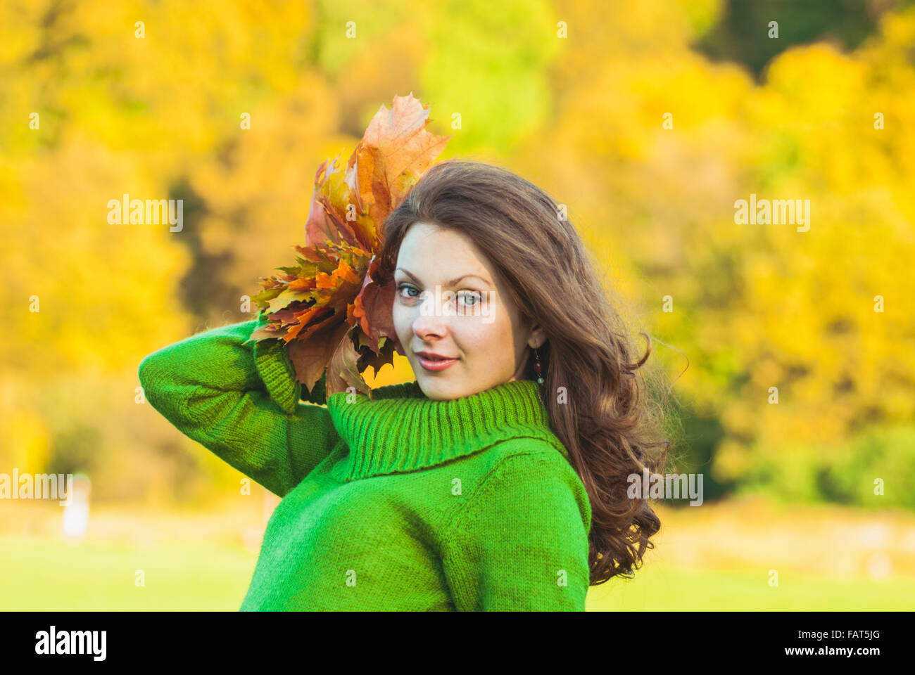 Beautiful woman with autumnal maple leaves Stock Photo - Alamy
