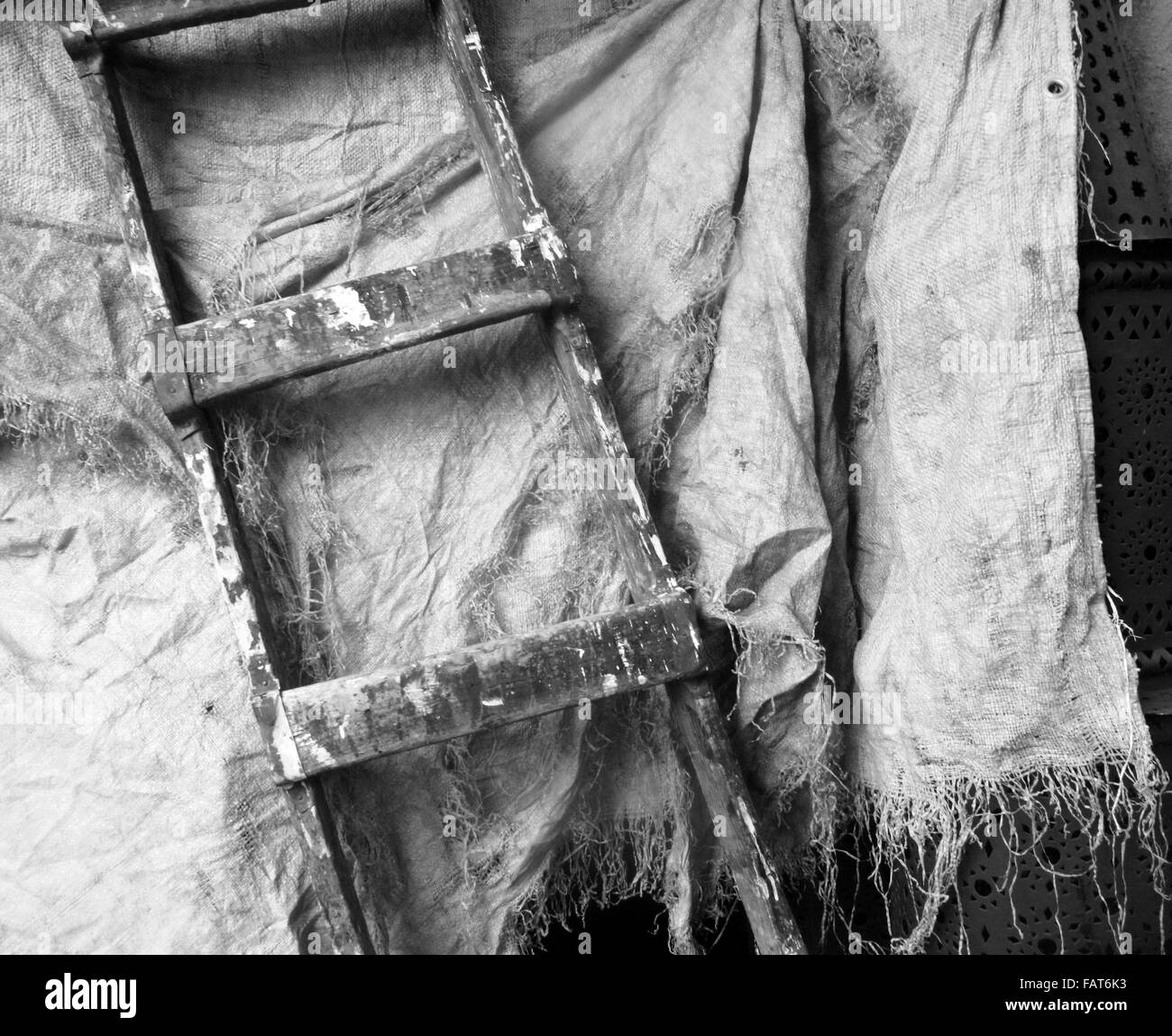 An old, wooden ladder with an old sheet. Stock Photo