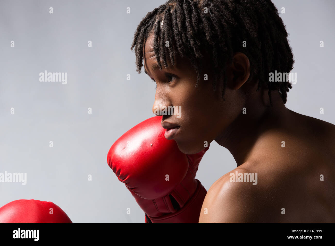 Young muscular athletic male boxer wearing blue boxing shorts and