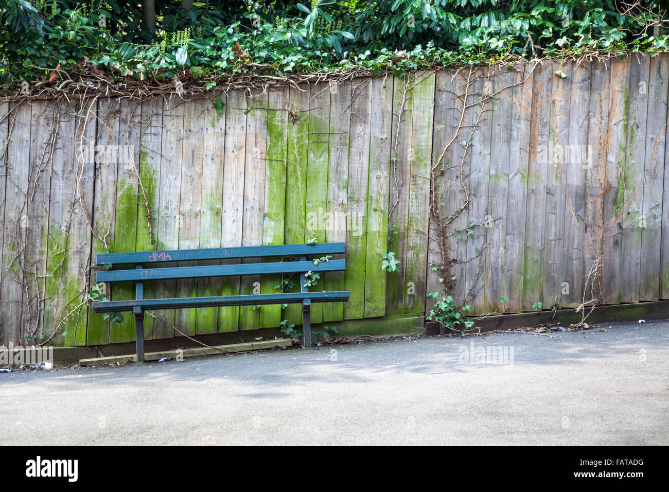 Slanted bench and fence on a slope (Highgate, London) Stock Photo