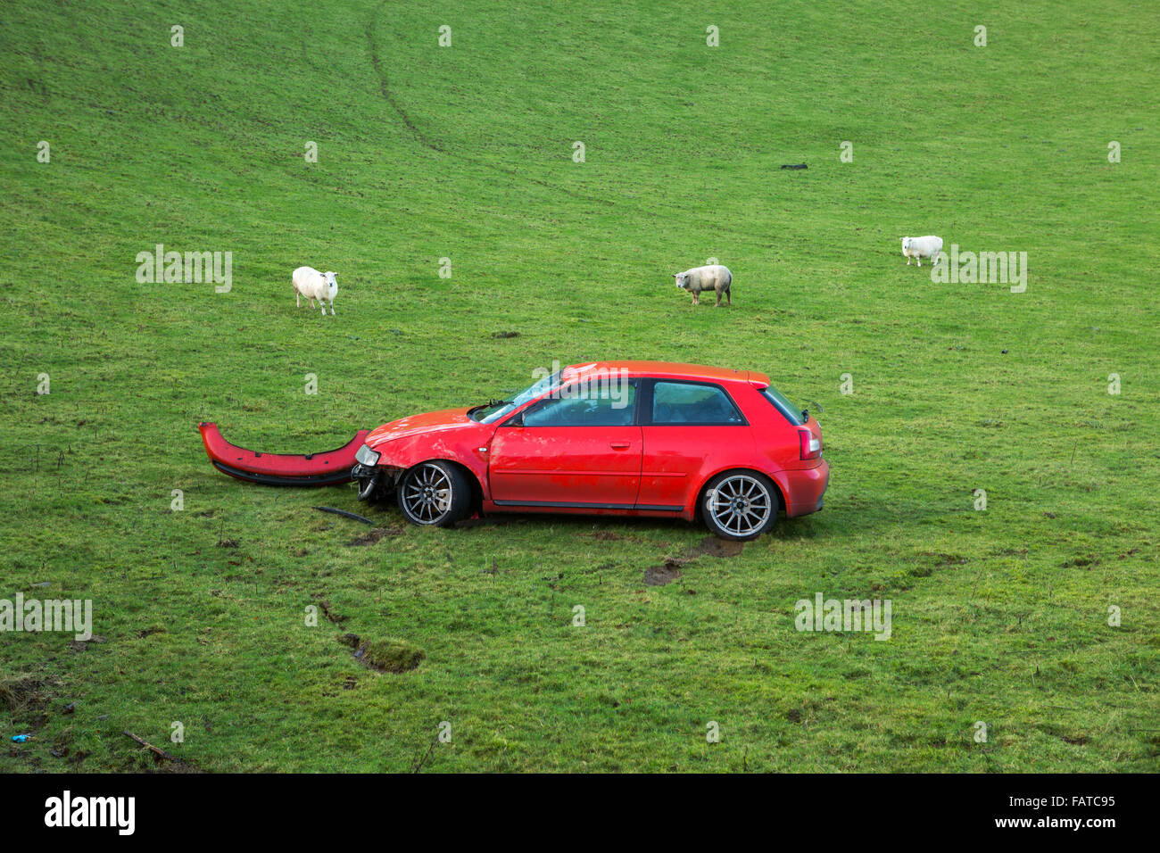 damaged red Audi thats gone off the road into a field Stock Photo