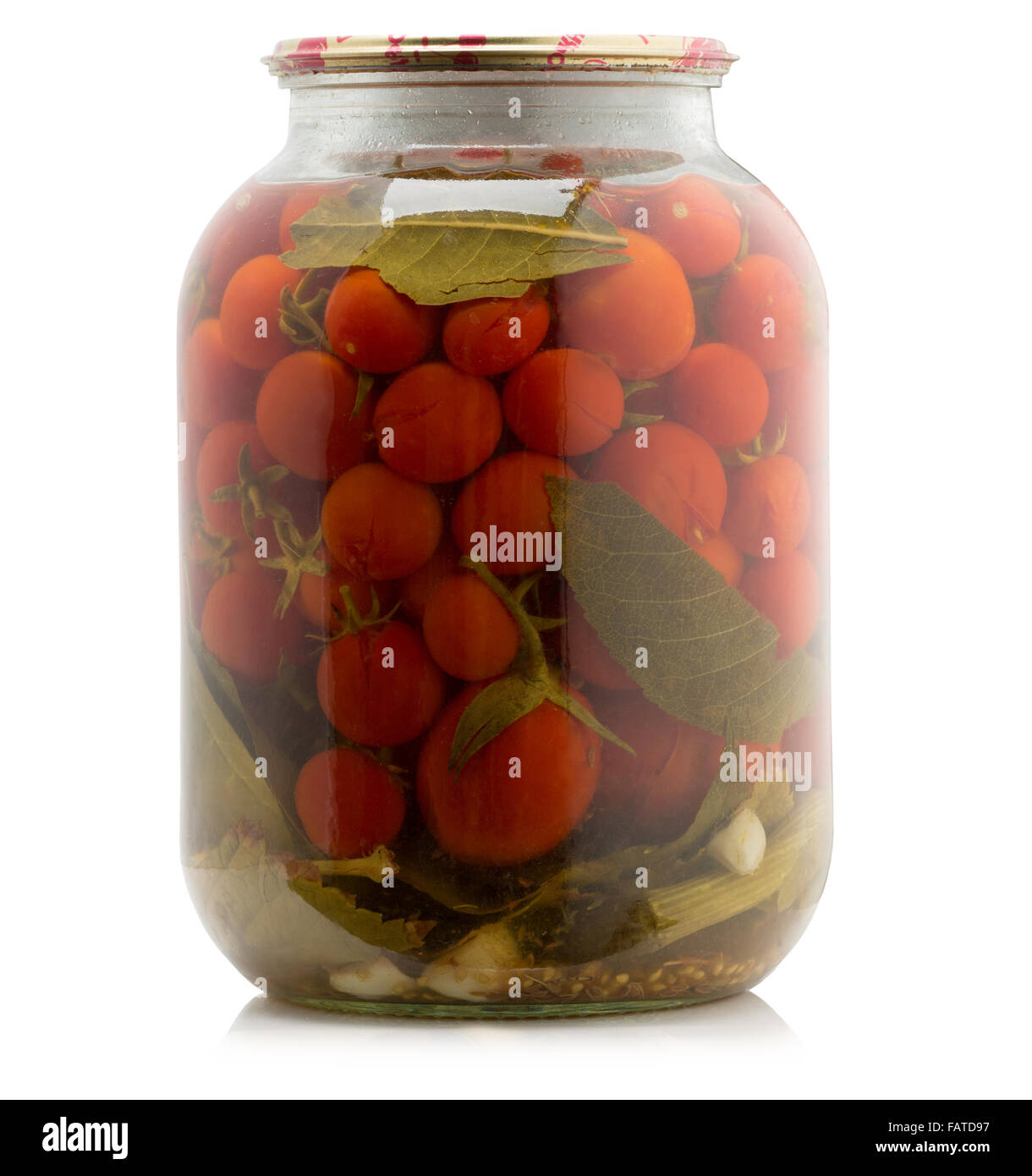 Marinated tomatoes canned in glass jar isolated on the white background. Stock Photo