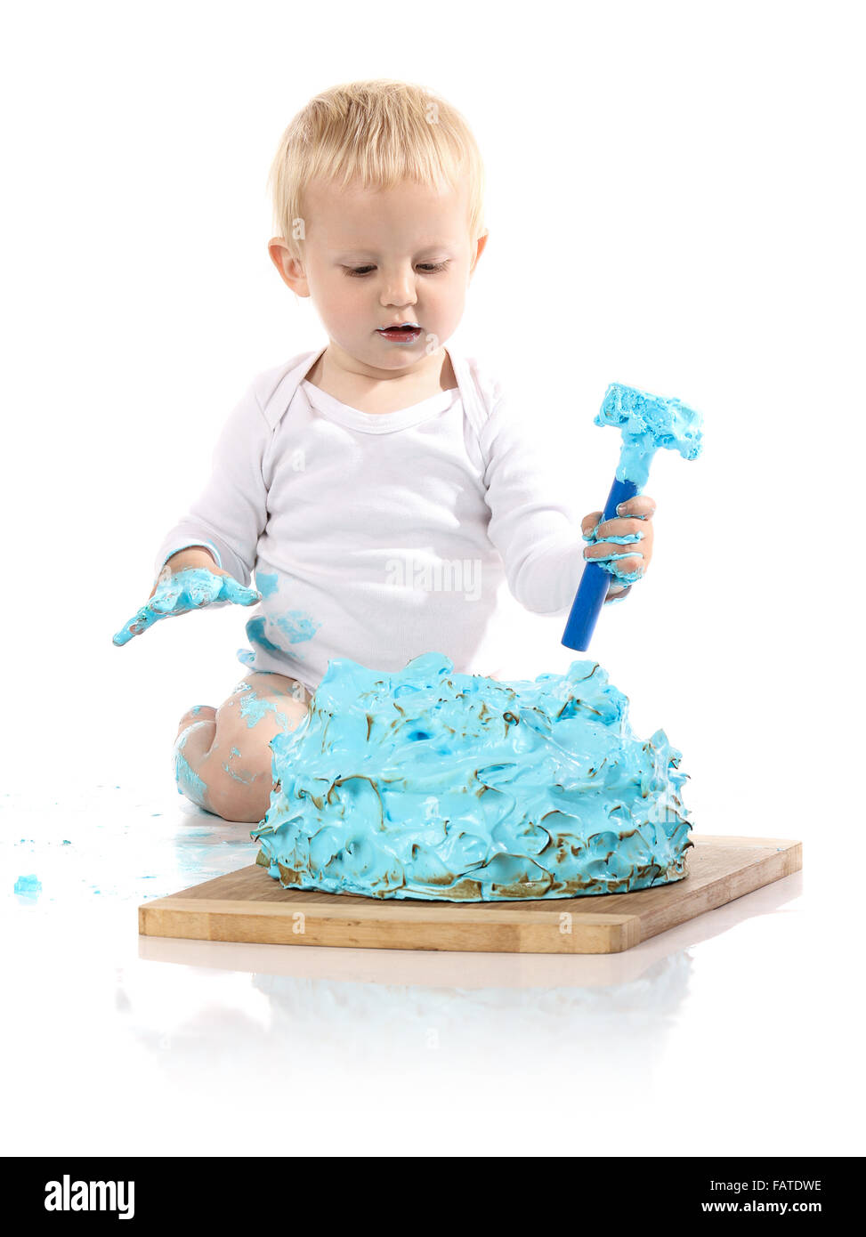 A One Year Old Baby Boy Smashing A Blue Iced Birthday Cake On A Stock Photo Alamy