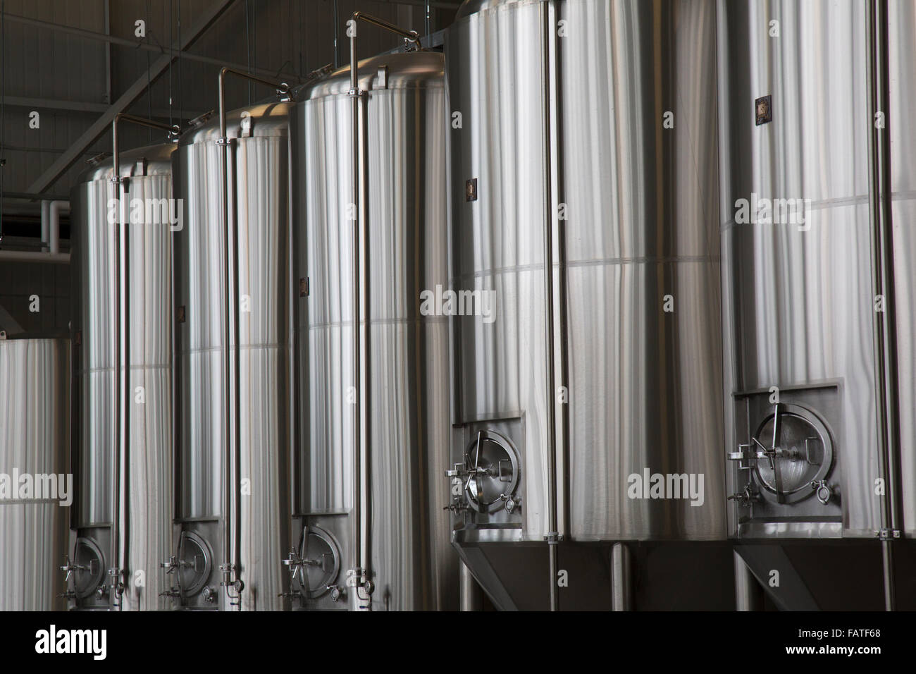 Stainless steel alcohol fermentation tanks in a brewery. Stock Photo