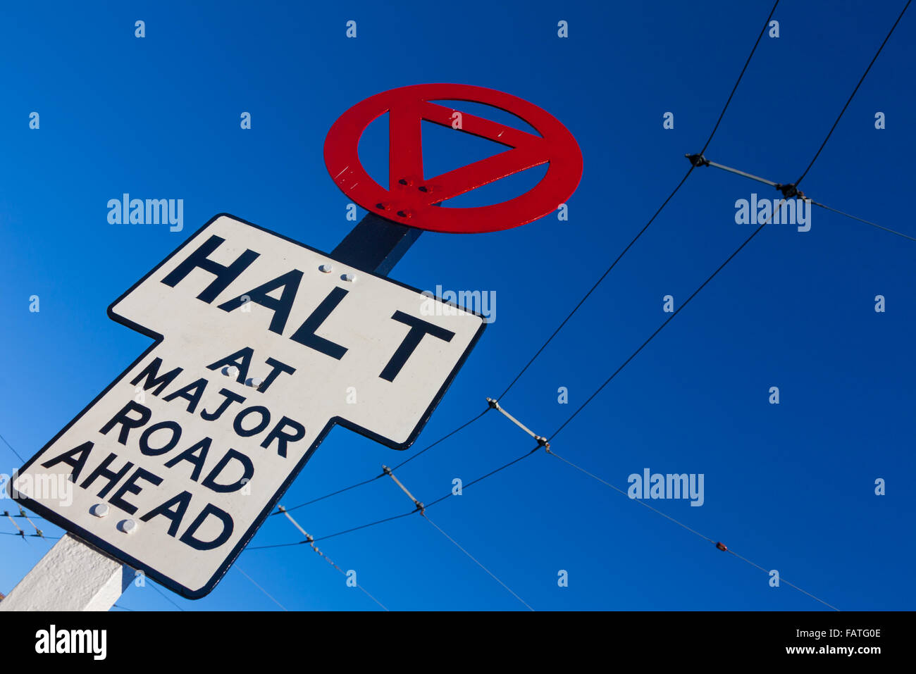 Early twentieth century roadsign for a tram or trolley bus, UK, saying halt at road. Stock Photo