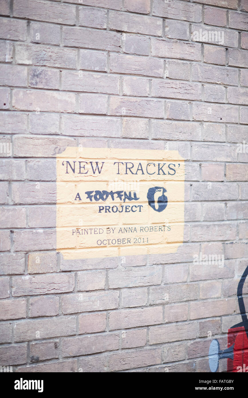 New Tracks mural painted by Anna Roberts from the Footfall Project depicting a steam railway locomotive and coaches train artwor Stock Photo