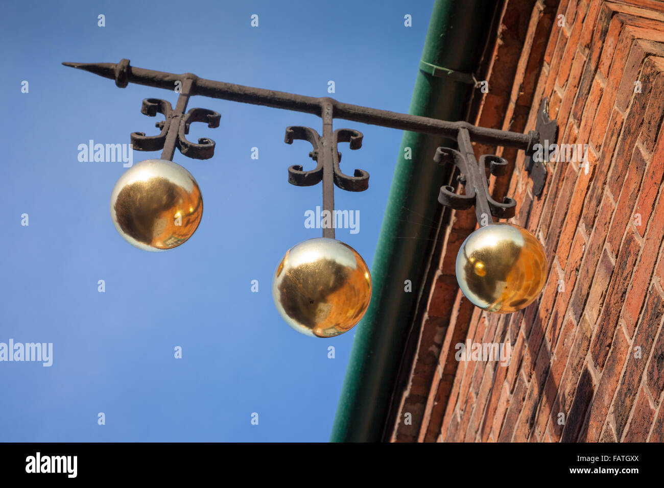 Pawn shop golden balls hanging sign outside an old fashioned pawnshop, Dudley UK Stock Photo
