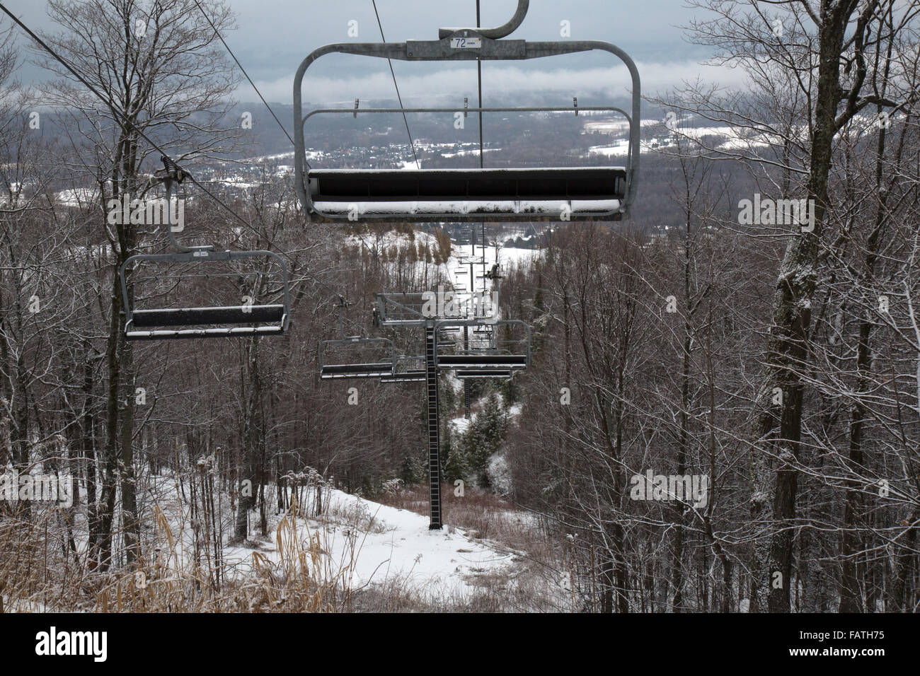 Empty chairs on the chair lift at the ski resorts at Collingwood, Ontario, Canada Stock Photo