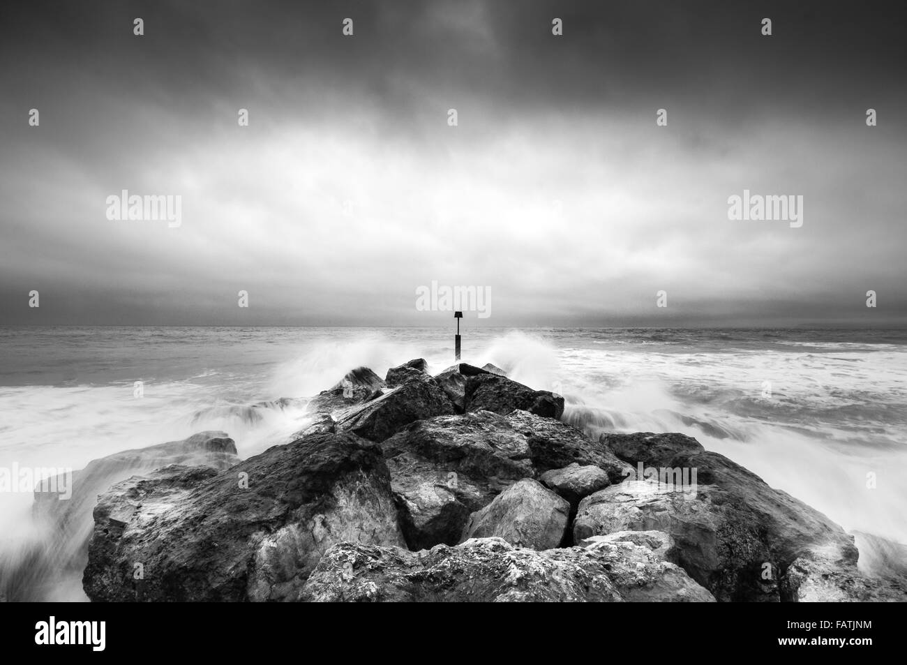 Dramatic stormy sea crashing against rocks Stock Photo