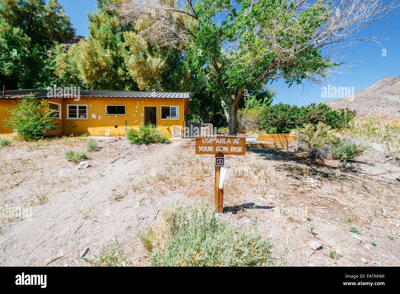 Use area at your own risk sign in an abandoned property in Death Valley, USA Stock Photo
