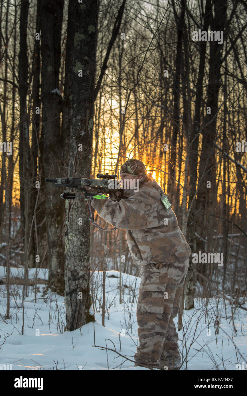 Crossbow hunter taking aim Stock Photo