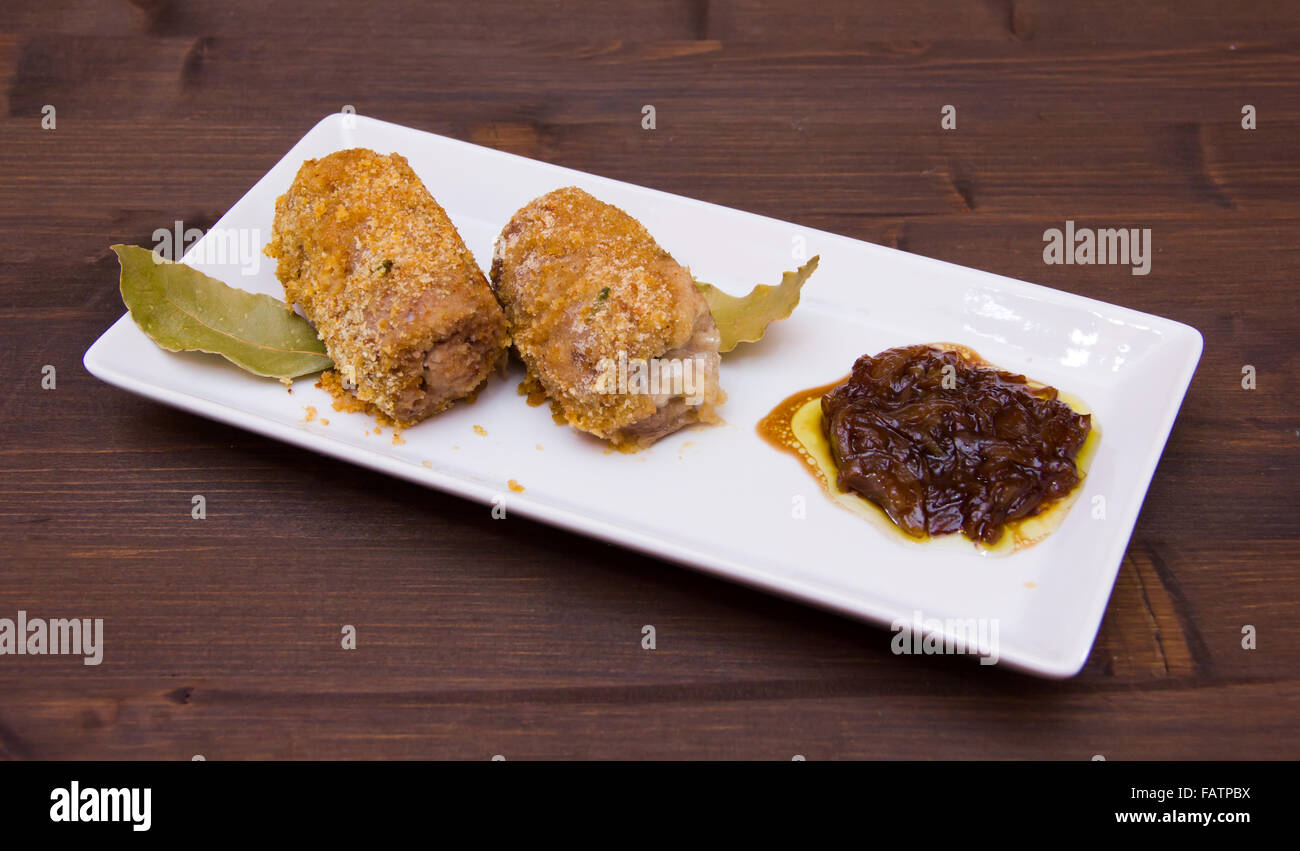 Breaded meat rolls on the tray on wooden table Stock Photo
