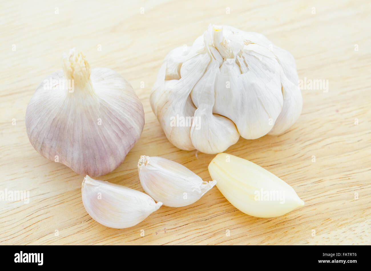 Organic garlic whole and cloves on the wooden background Stock Photo ...