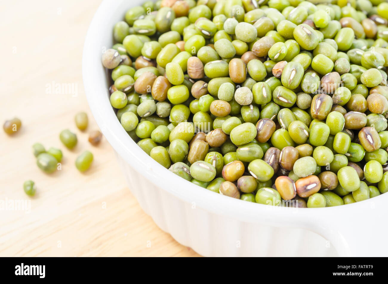 Healthy vegetarian super foods ingredient mung beans in cup on wooden background. Stock Photo