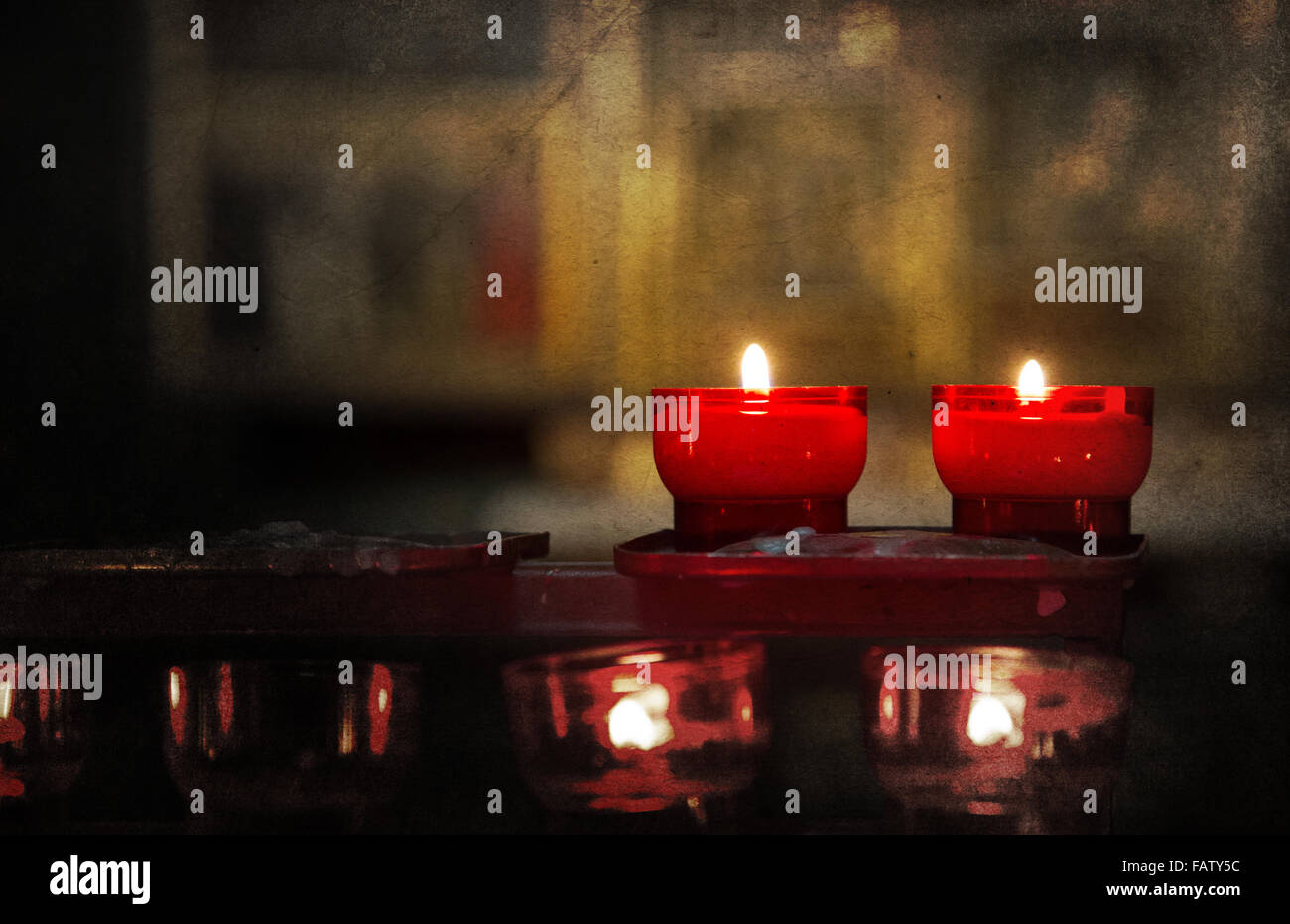 Candle burning inside an old Catholic church Vintage dirty look Stock