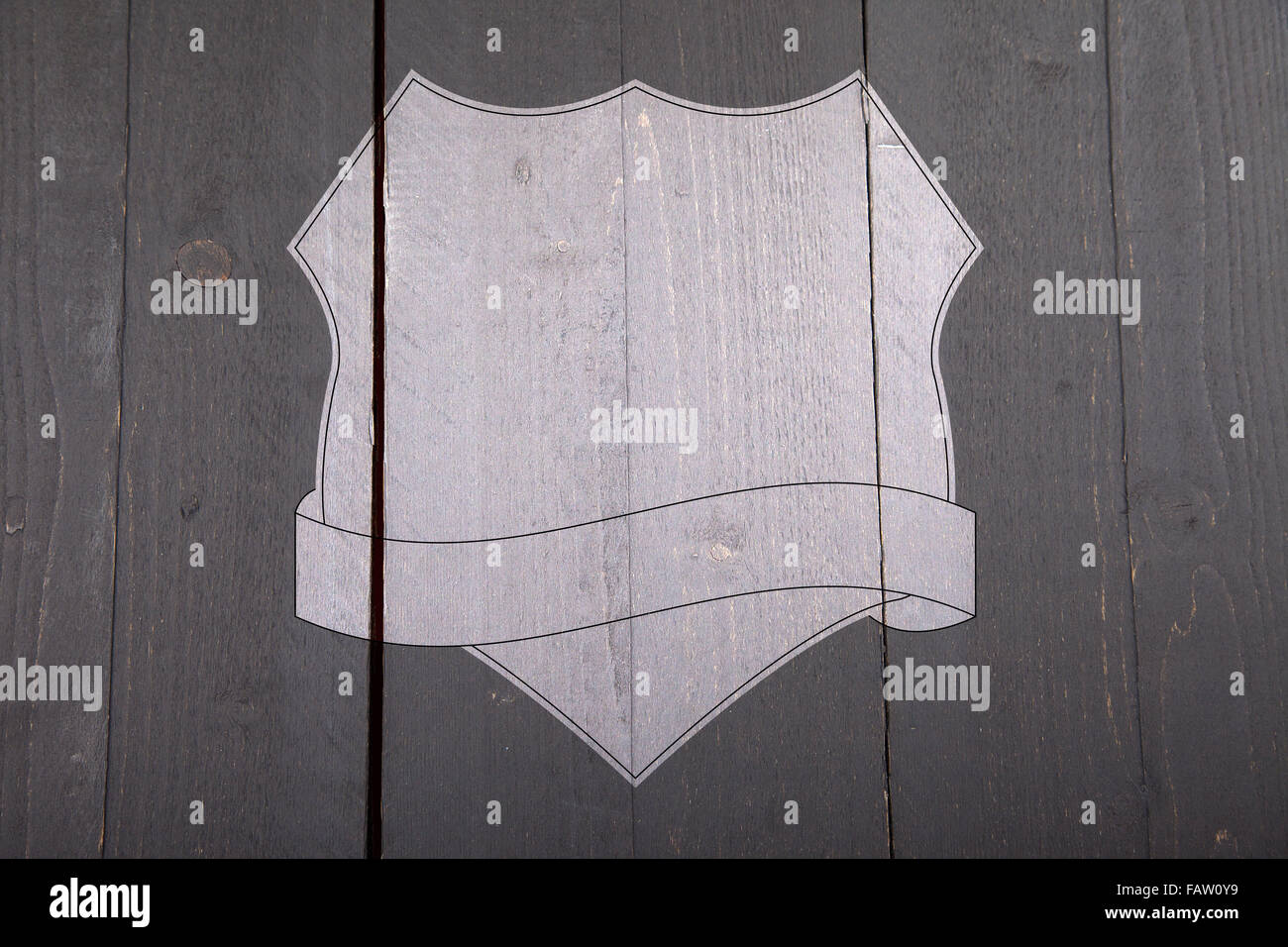 White shield on black wooden background Stock Photo