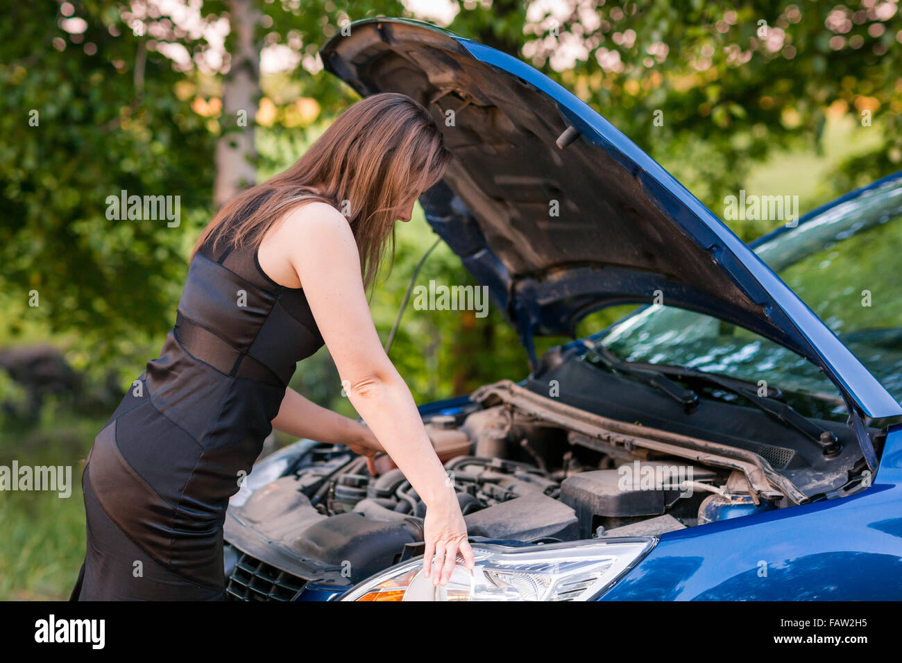 Beautiful business woman near her broken car, tring to repair Stock ...