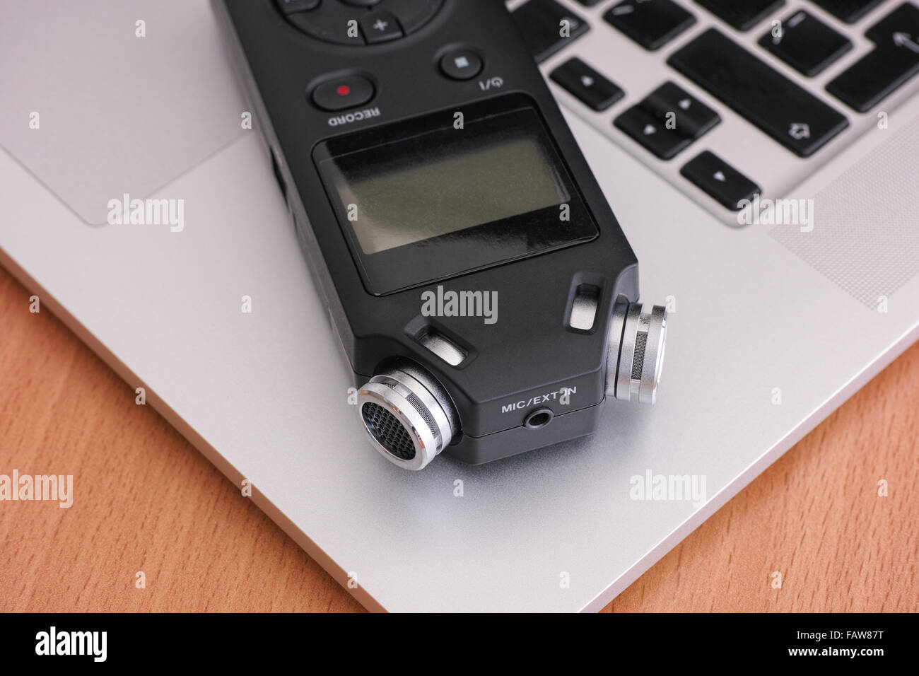 Audio recorder and laptop. Close up. Stock Photo