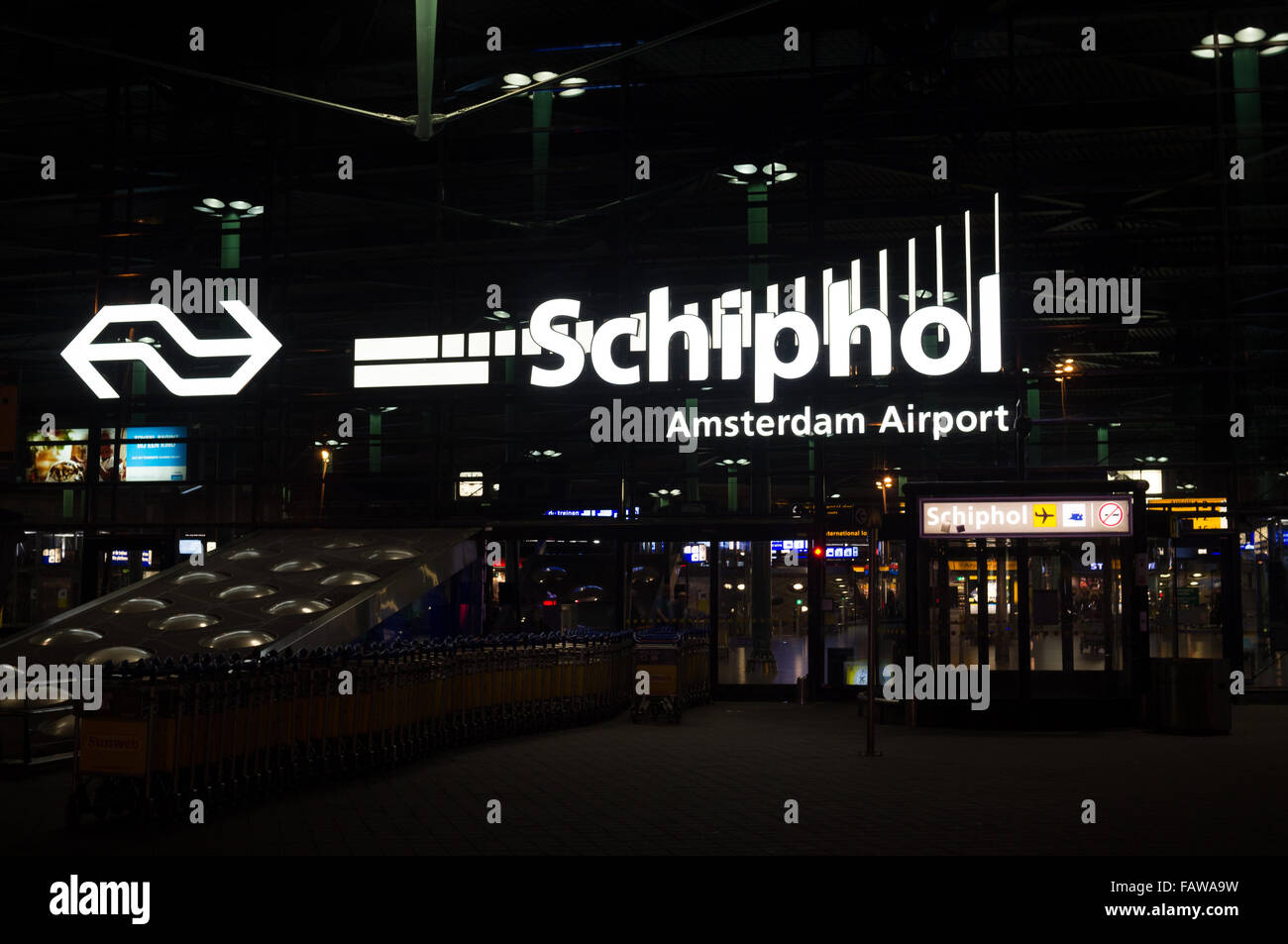 Amsterdam Schiphol Airport Train Station entrance and logo in the night Stock Photo