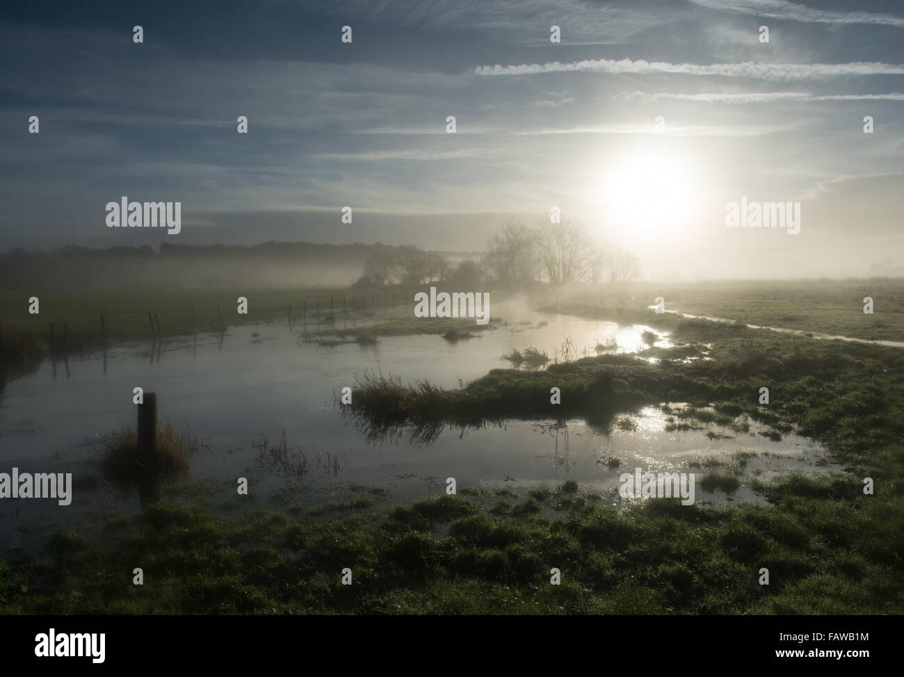 Serene misty morning landscape in the Hampshire countryside in winter ...