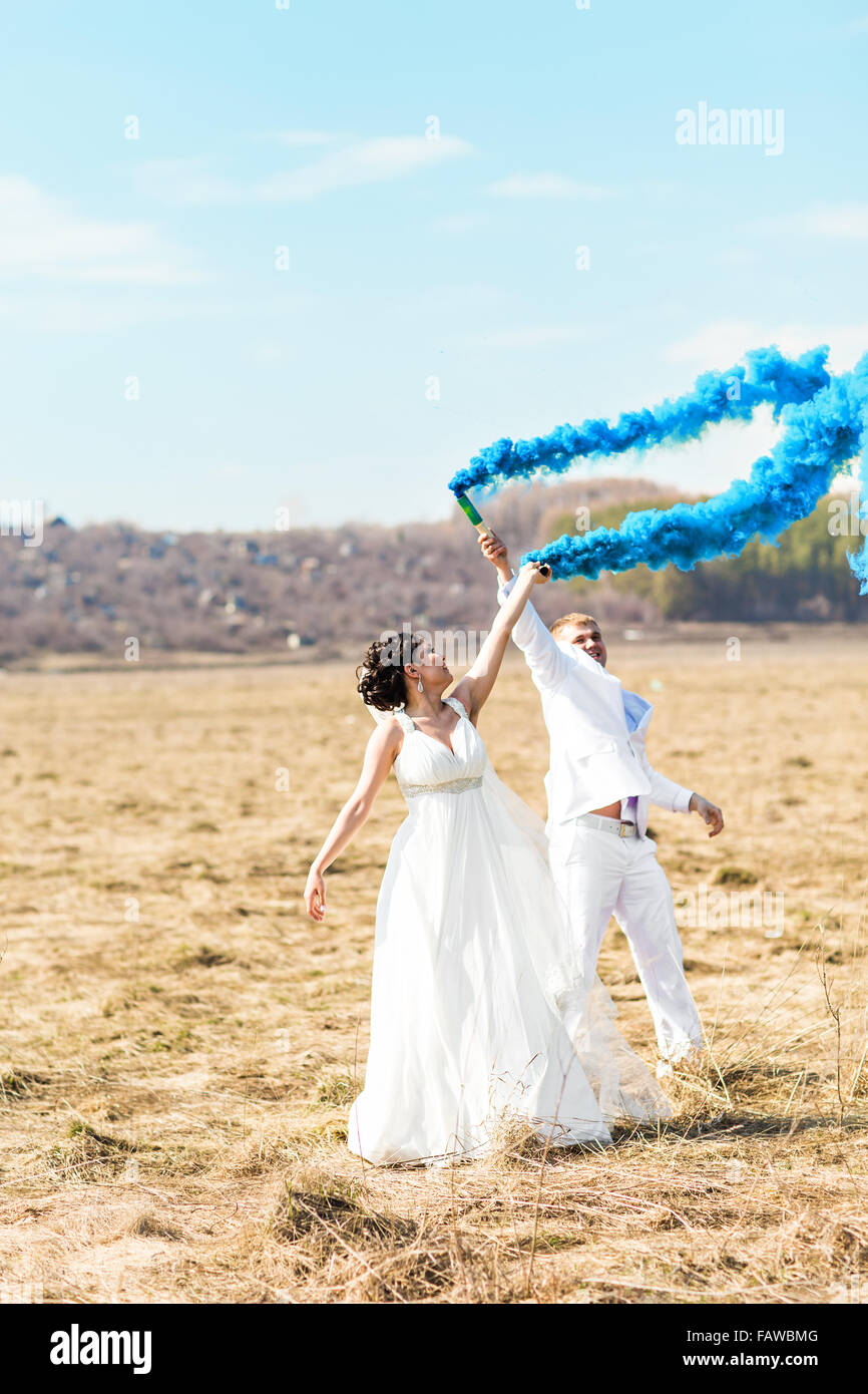 Wedding couple with blue smoke in the park Stock Photo - Alamy Wedding couple with blue smoke in the park Stock Photo - Alamy