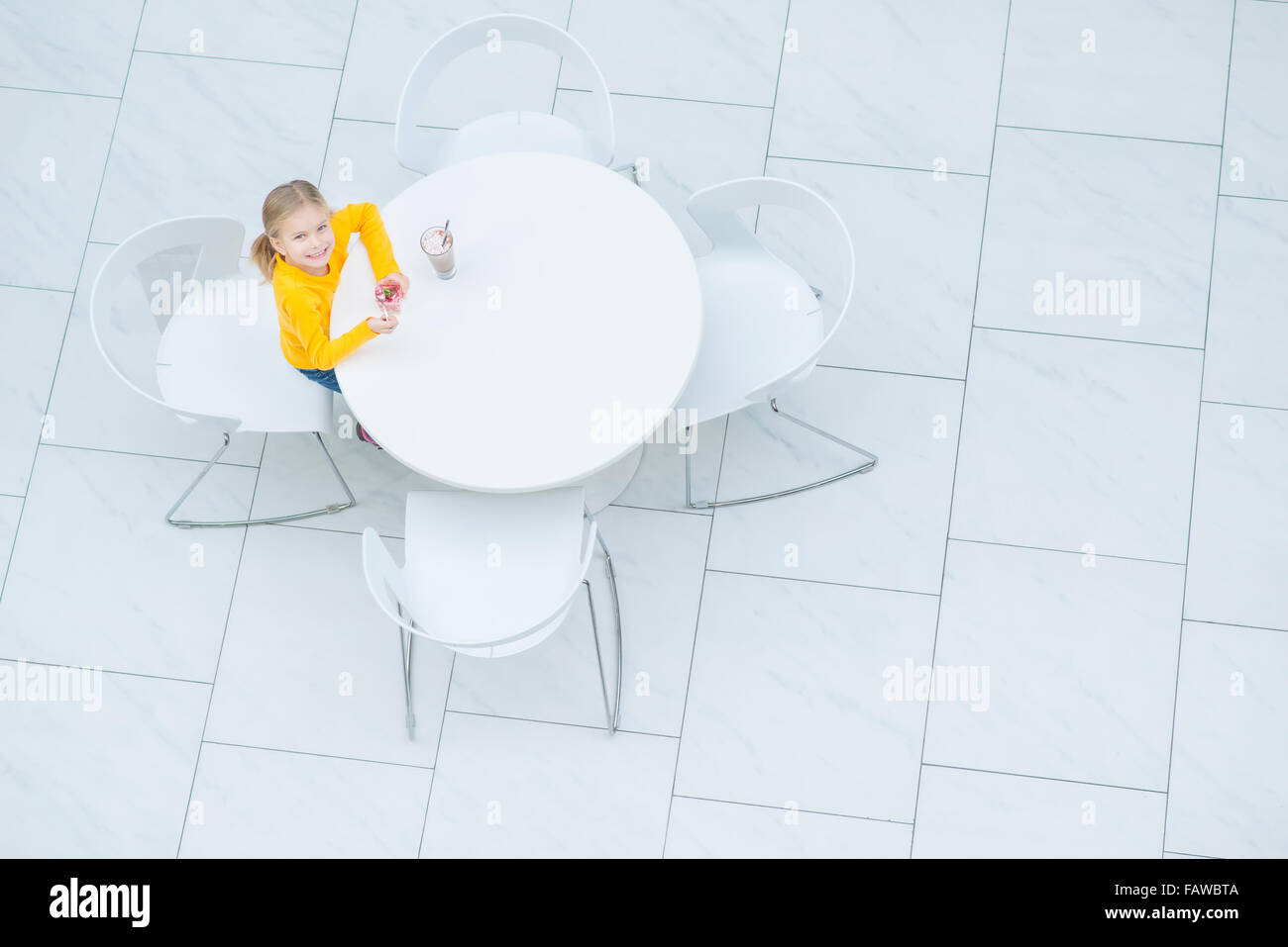 Little girl sitting in the cafe Stock Photo - Alamy