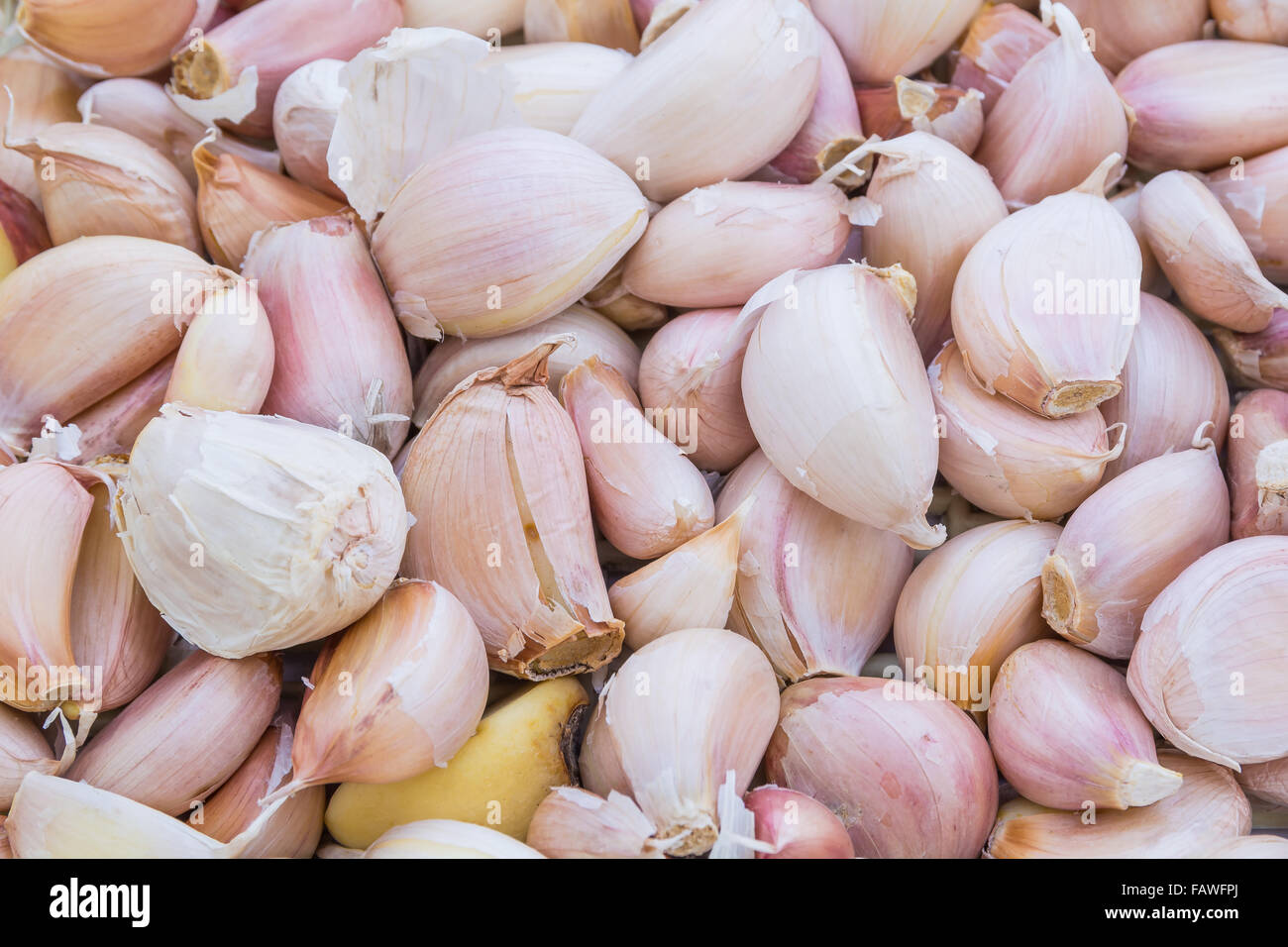 Closeup of peeled cloves of garlic, background Stock Photo
