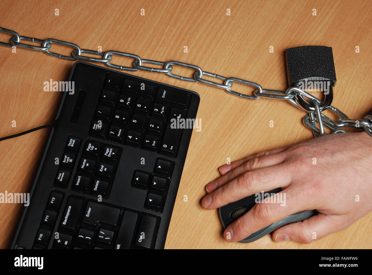 the man chained to the workplace, working at a computer Stock Photo