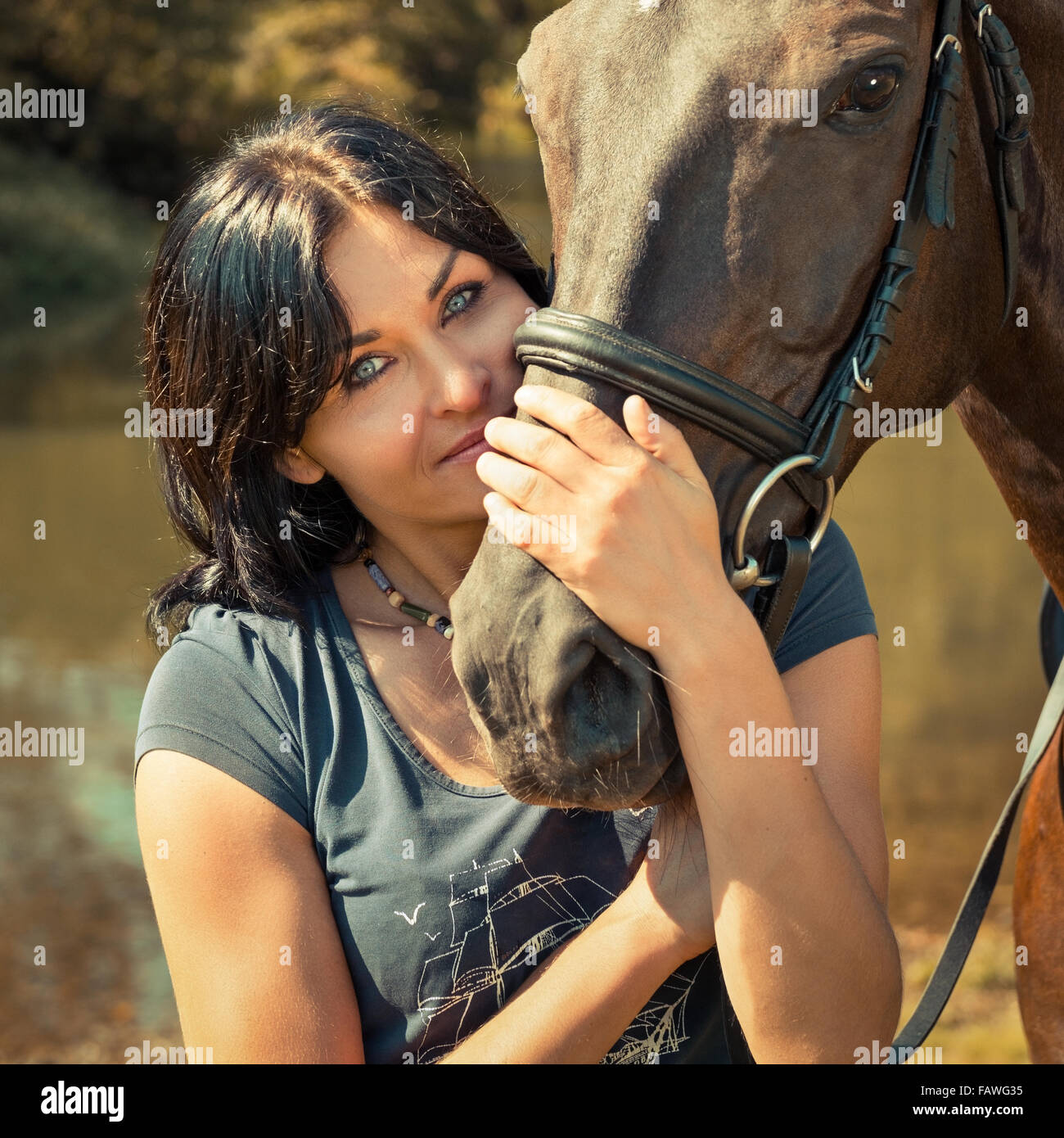 Portrait of a beautiful young woman with a horse Stock Photo