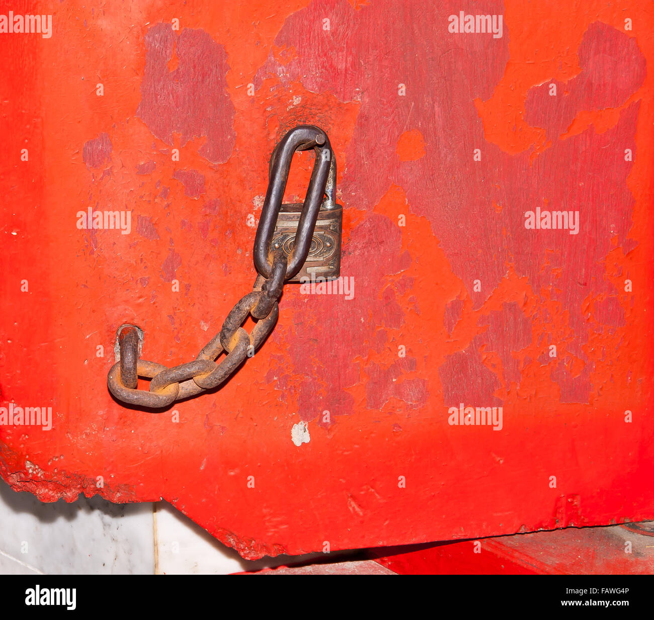 Steel chain and padlock hanging on the red door Stock Photo - Alamy