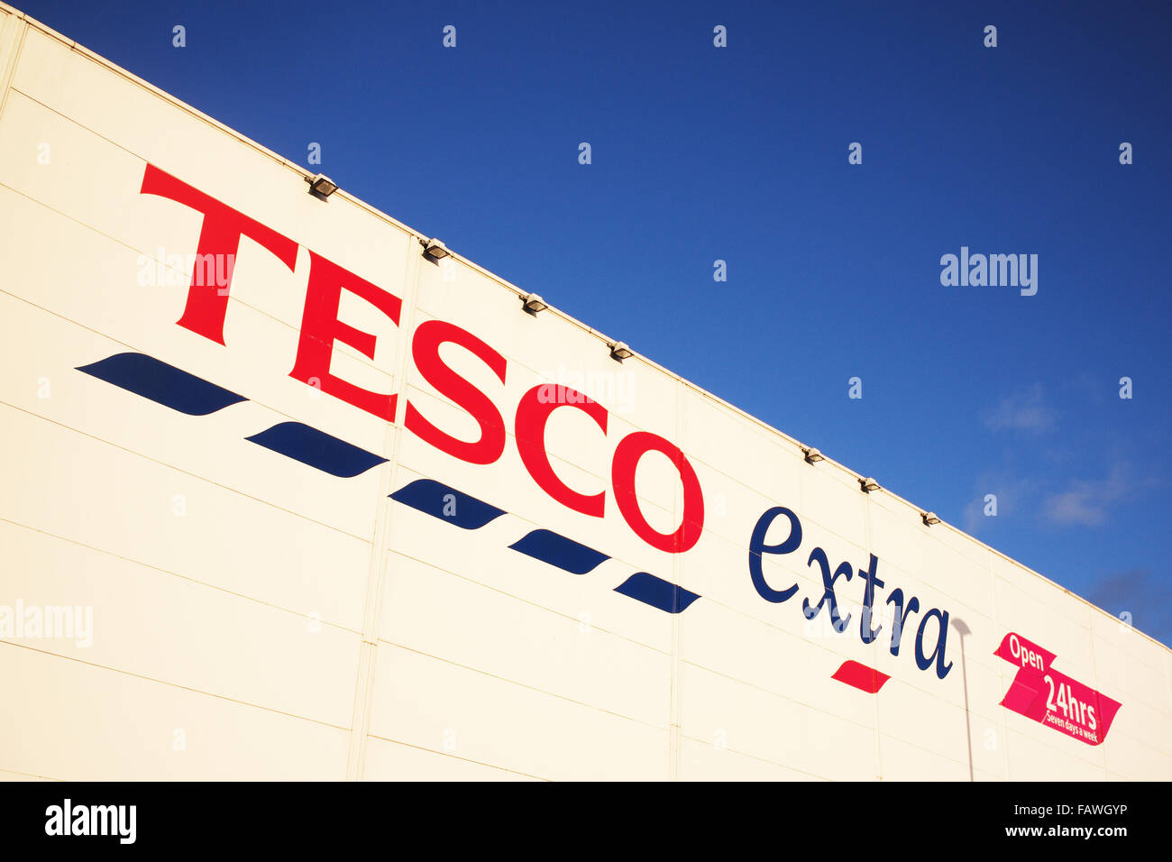 Tesco extra shop sign against a blue sky Stock Photo