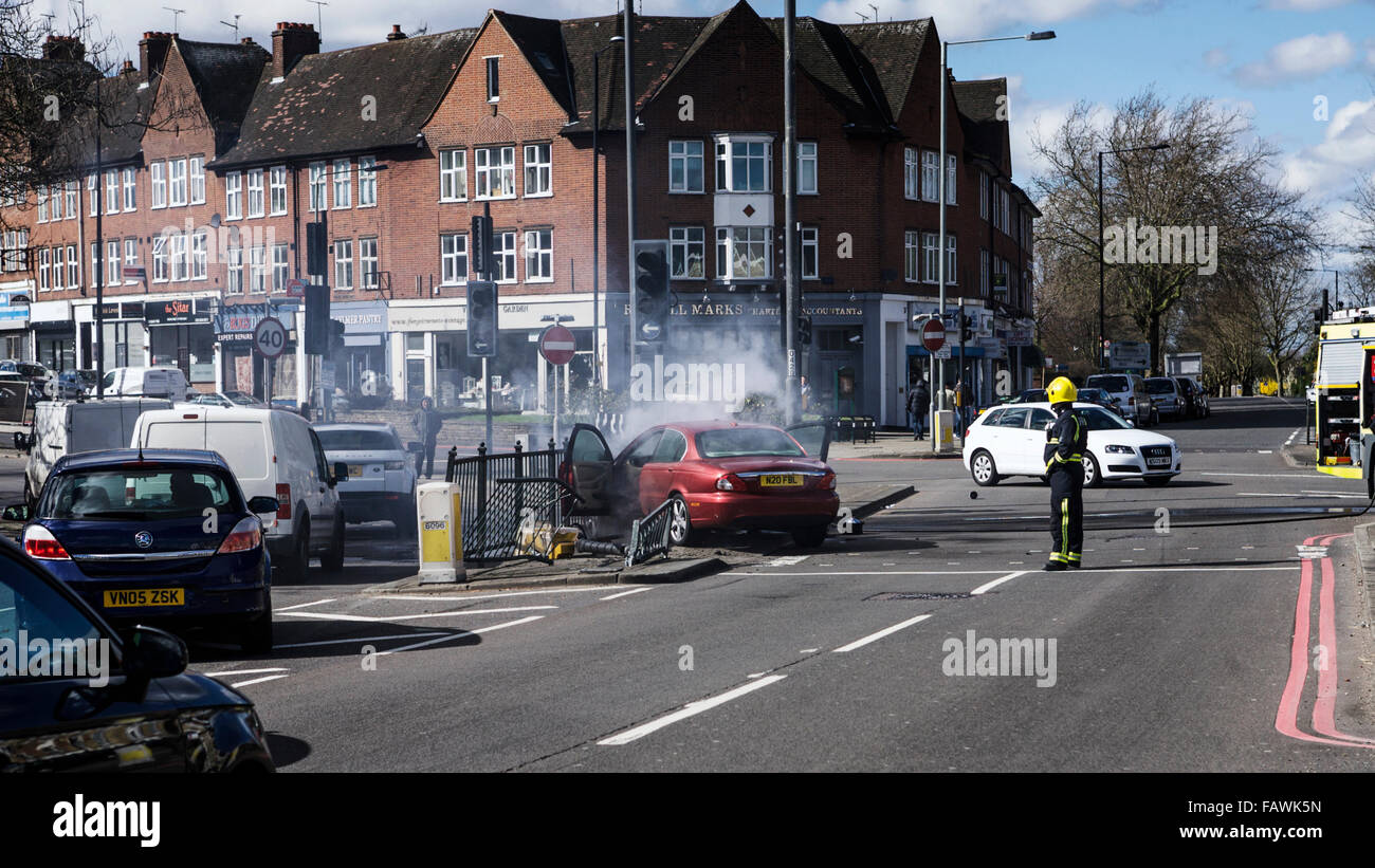 Car crash, fireman in attendance, north London, UK. Smoke coming from car engine. London car crash. Car accident scene. Car insurance UK. Stock Photo