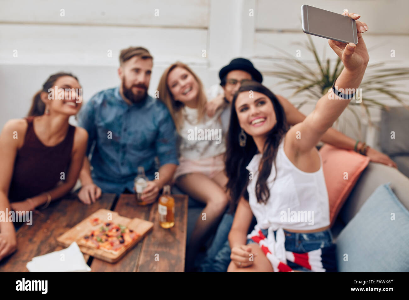 Group of friends having a party on the rooftop making a selfie to remember this perfect moment. Happy and joyful young people ta Stock Photo