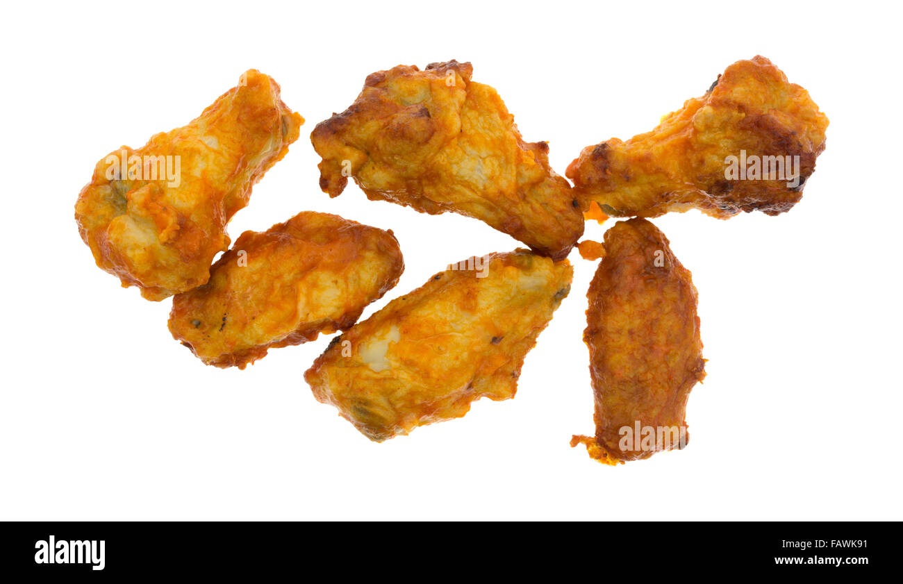 A serving of buffalo style flavored chicken thighs and wings isolated