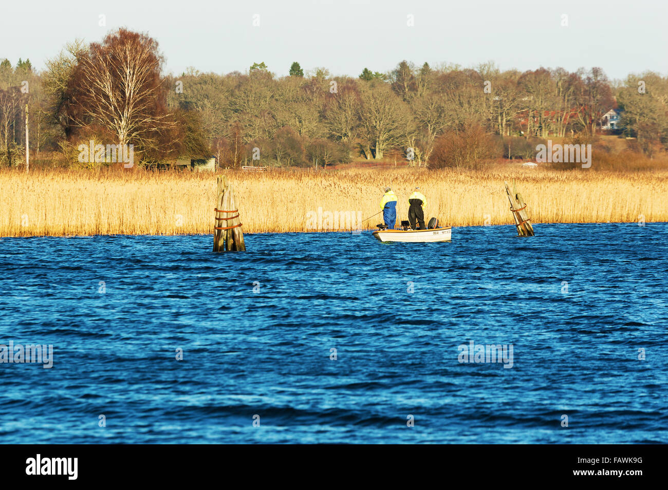 Ronneby, Sweden - December 30, 2015: Two persons fishing from a small open boat in late December. Sweden had very high average t Stock Photo