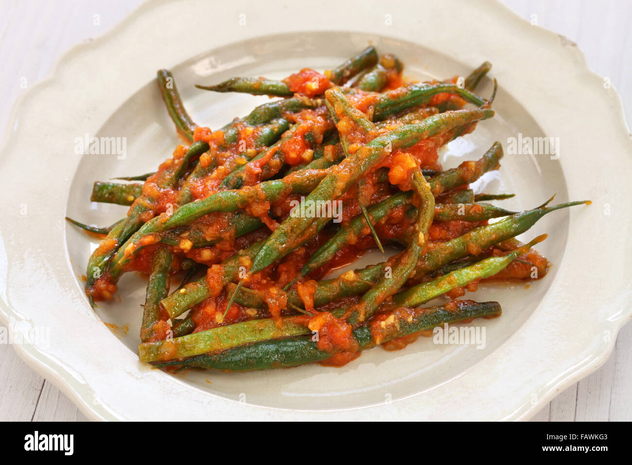 braised green beans isolated on white wooden background Stock Photo