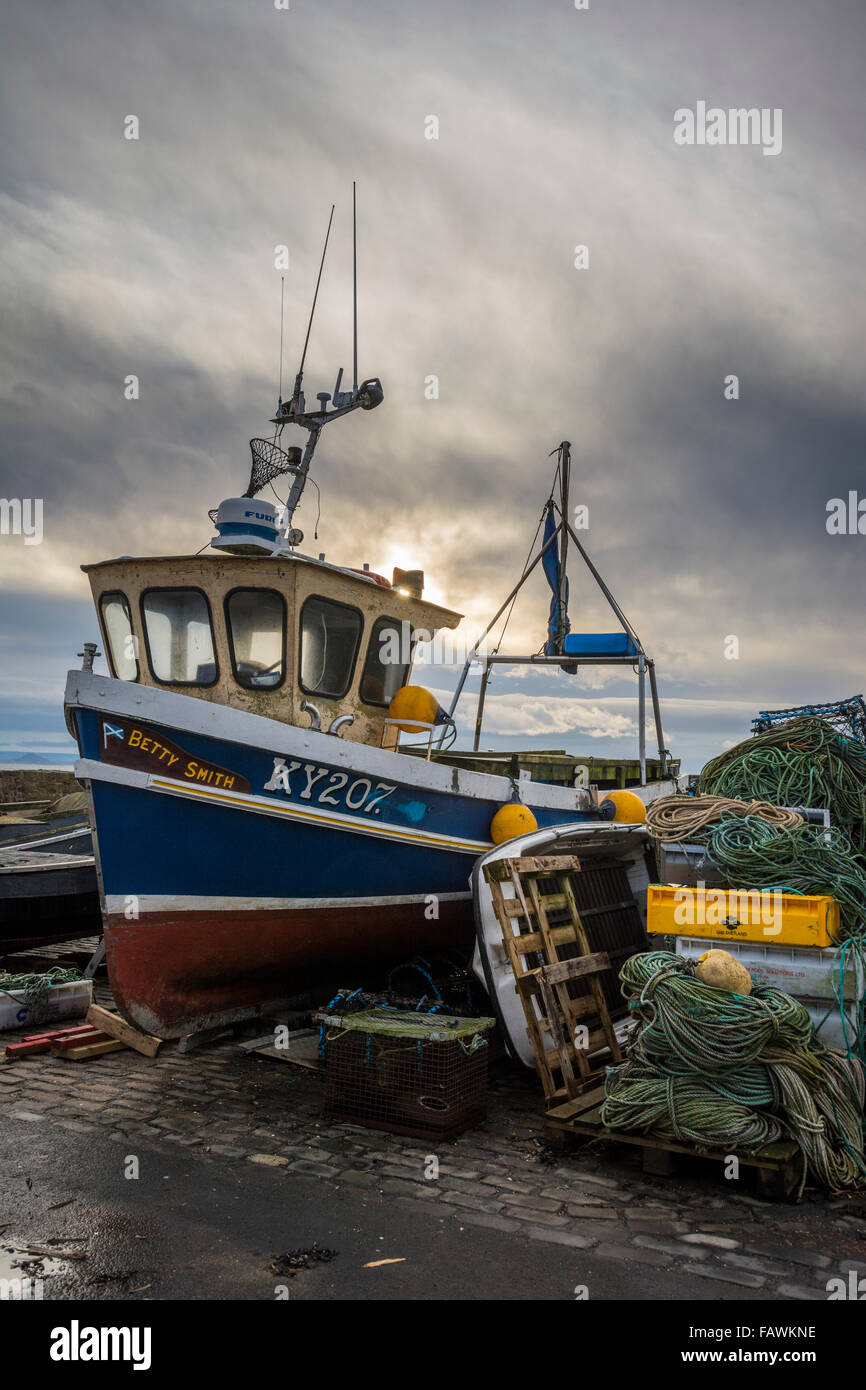 Fishing boat and paraphenalia on the quayside in the pretty fishing village of Pittenweem on the coast of Fife, Scotland Stock Photo