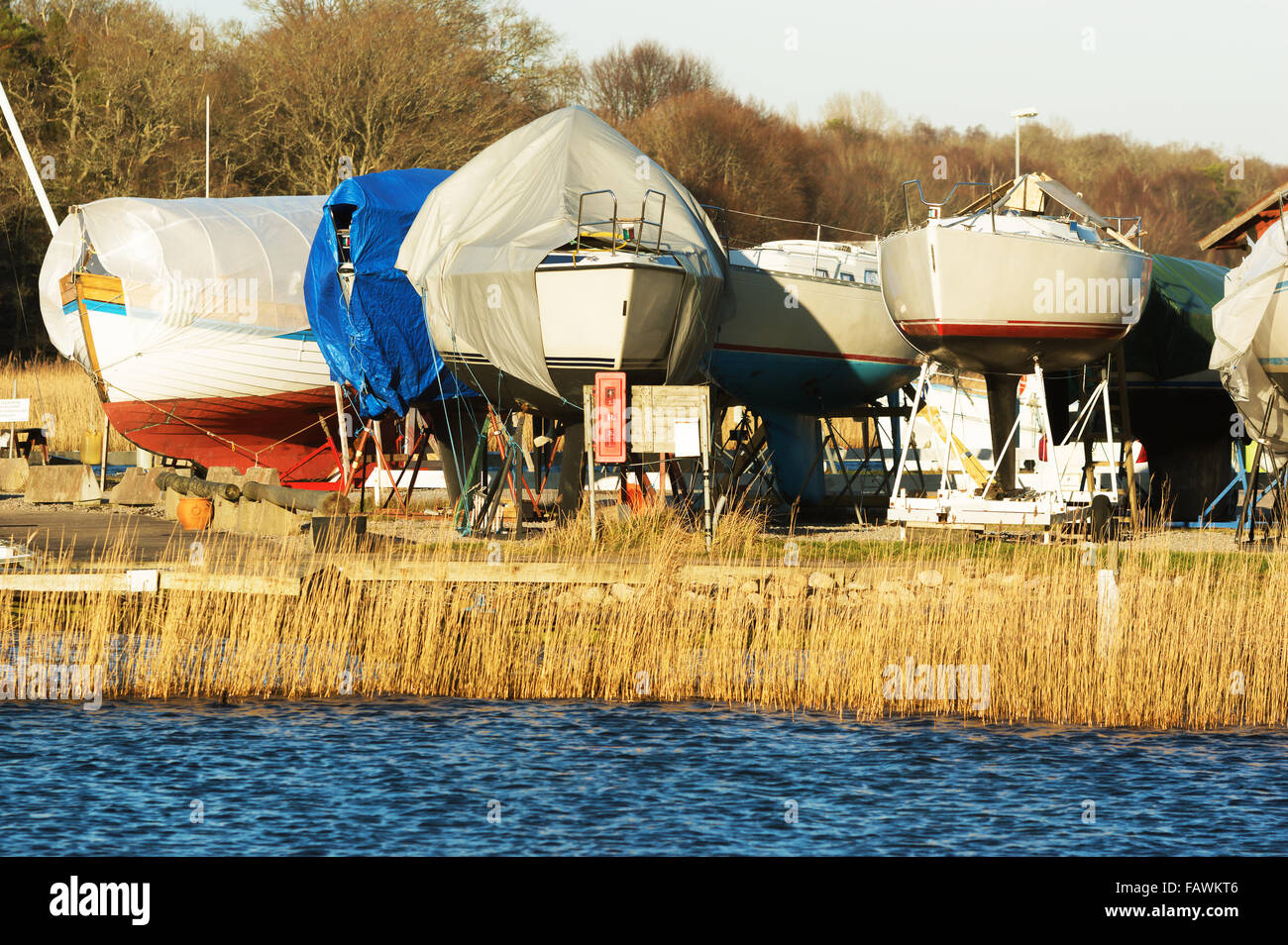 Boats in winter storage covered with tarps and supported by