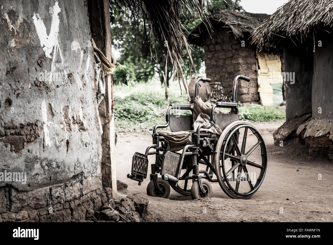 Wheelchair outside a house; Uganda Stock Photo Alamy