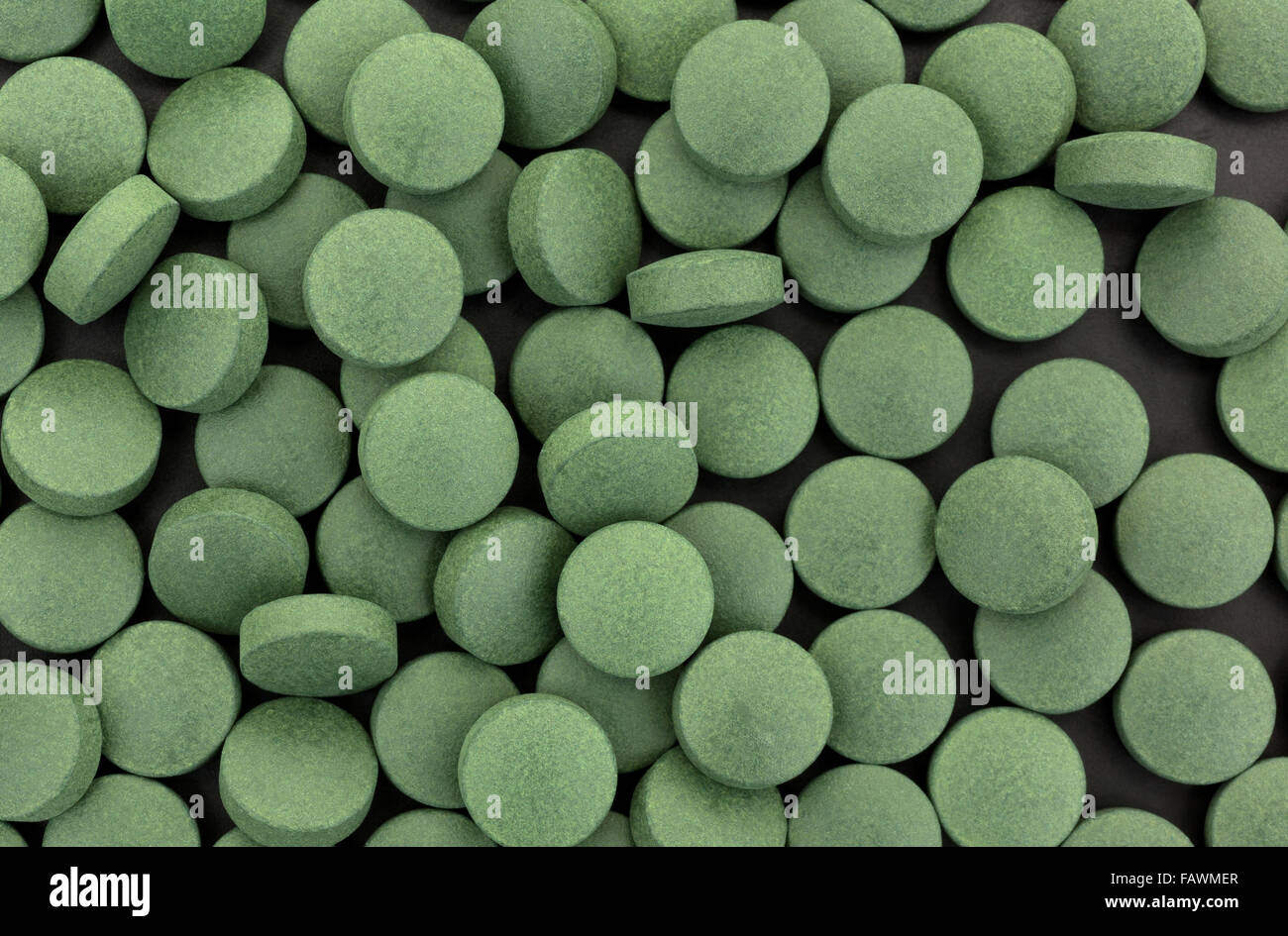 Top view of green iron supplement tablets on a black background Stock Photo  - Alamy