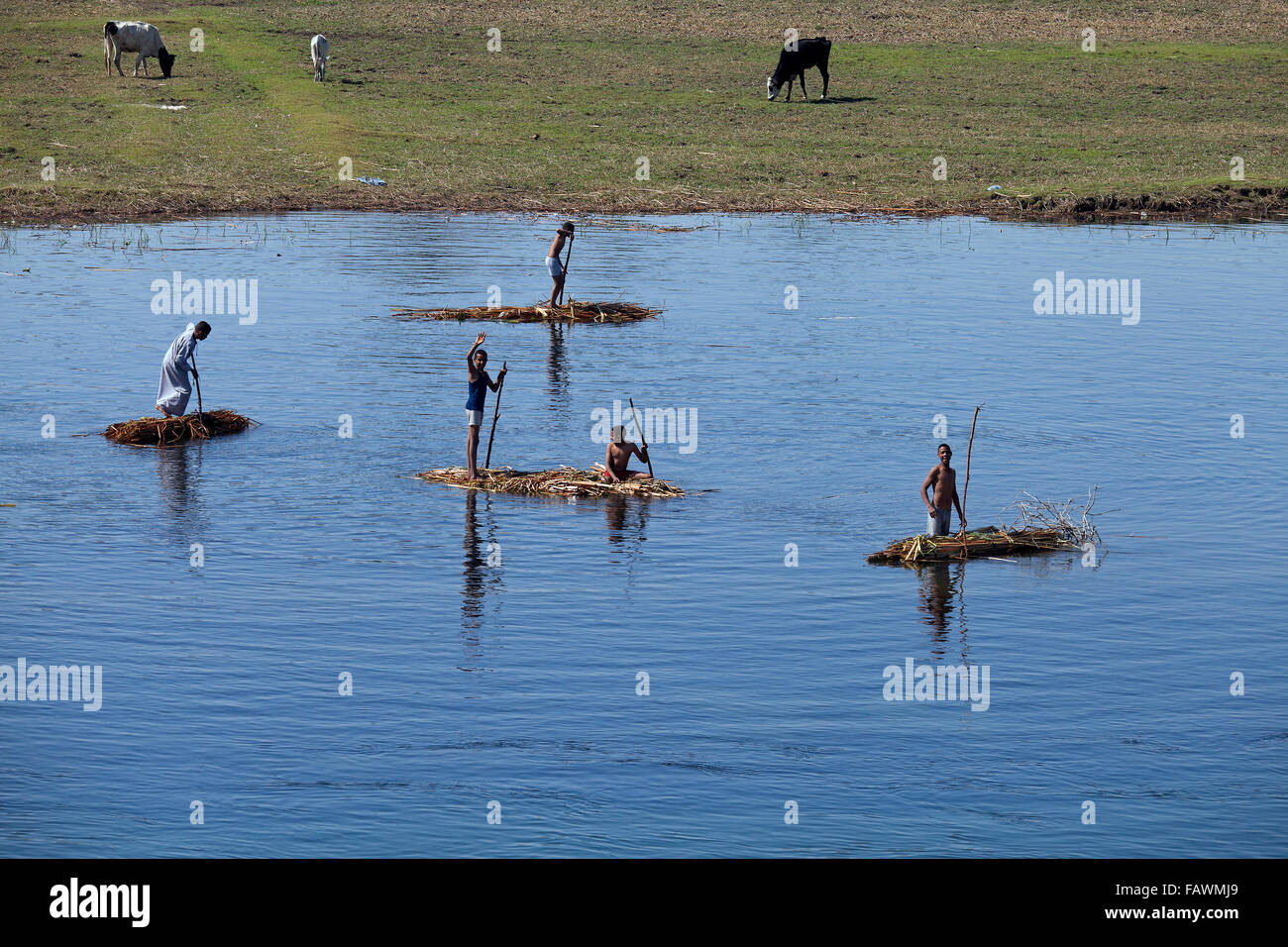 Egyptian children on simple papyrus rafts on the river Nile near Luxor, Egypt Stock Photo